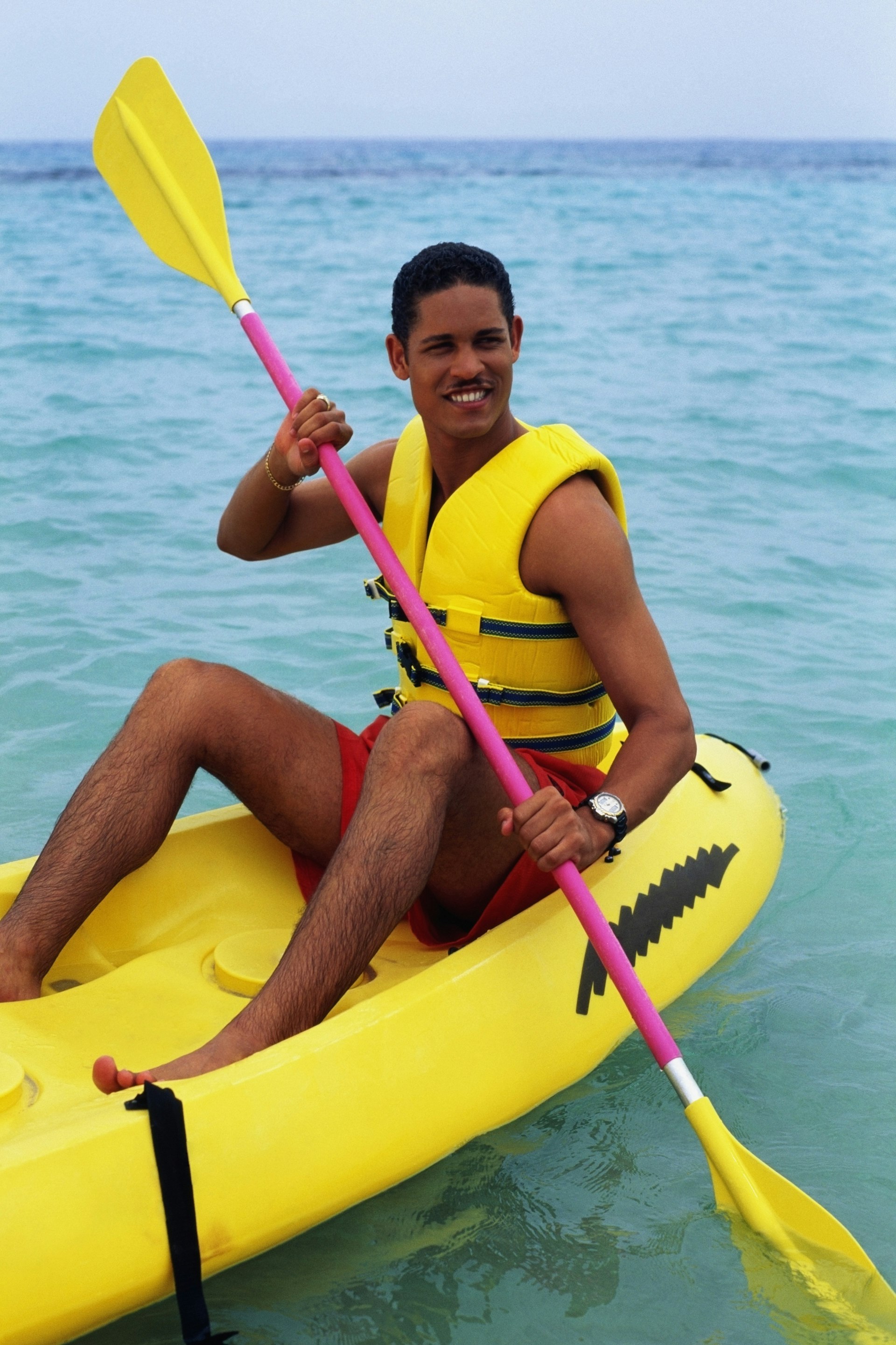 A man is boating in an inflatable kayak in Discovery Bay, Jamaica