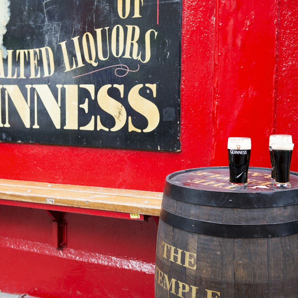 Dublin, Ireland - May 31, 2013: Pints of Guinness beer sit on a barrel outside Temple Bar, established in 1840 and located in the Temple Bar district of Dublin.