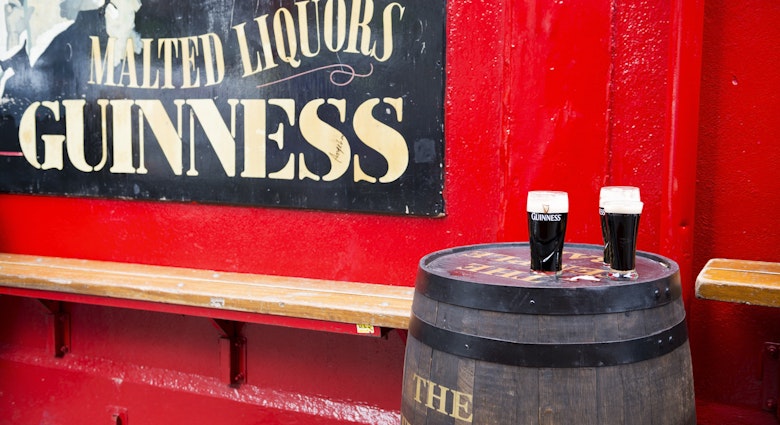 Dublin, Ireland - May 31, 2013: Pints of Guinness beer sit on a barrel outside Temple Bar, established in 1840 and located in the Temple Bar district of Dublin.