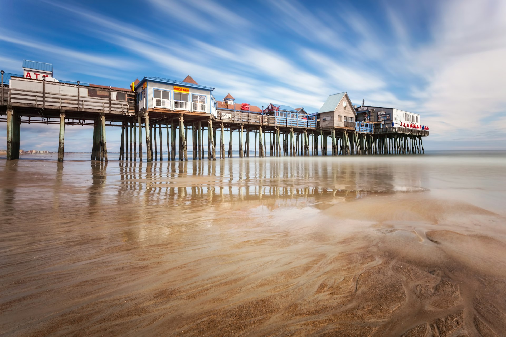 The Pier at Old Orchard Beach, Maine. Long exposure during the day, showing motion of the cloudy sky.