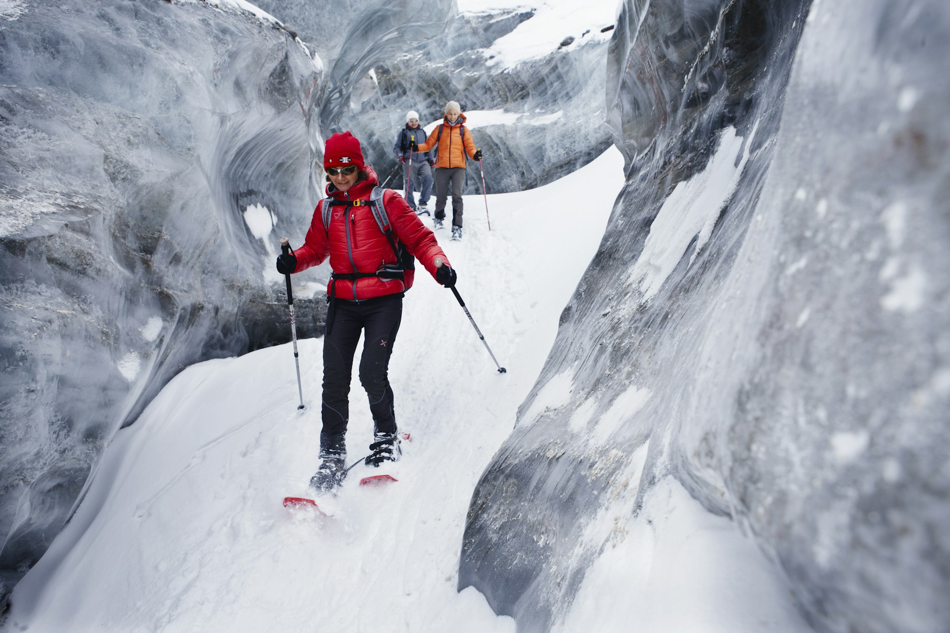 Group of people with snowshoes exploring glacier