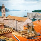 View of the Adriatic Sea from the tiled rooftops of the old town in Dubrovnik, Croatia.
