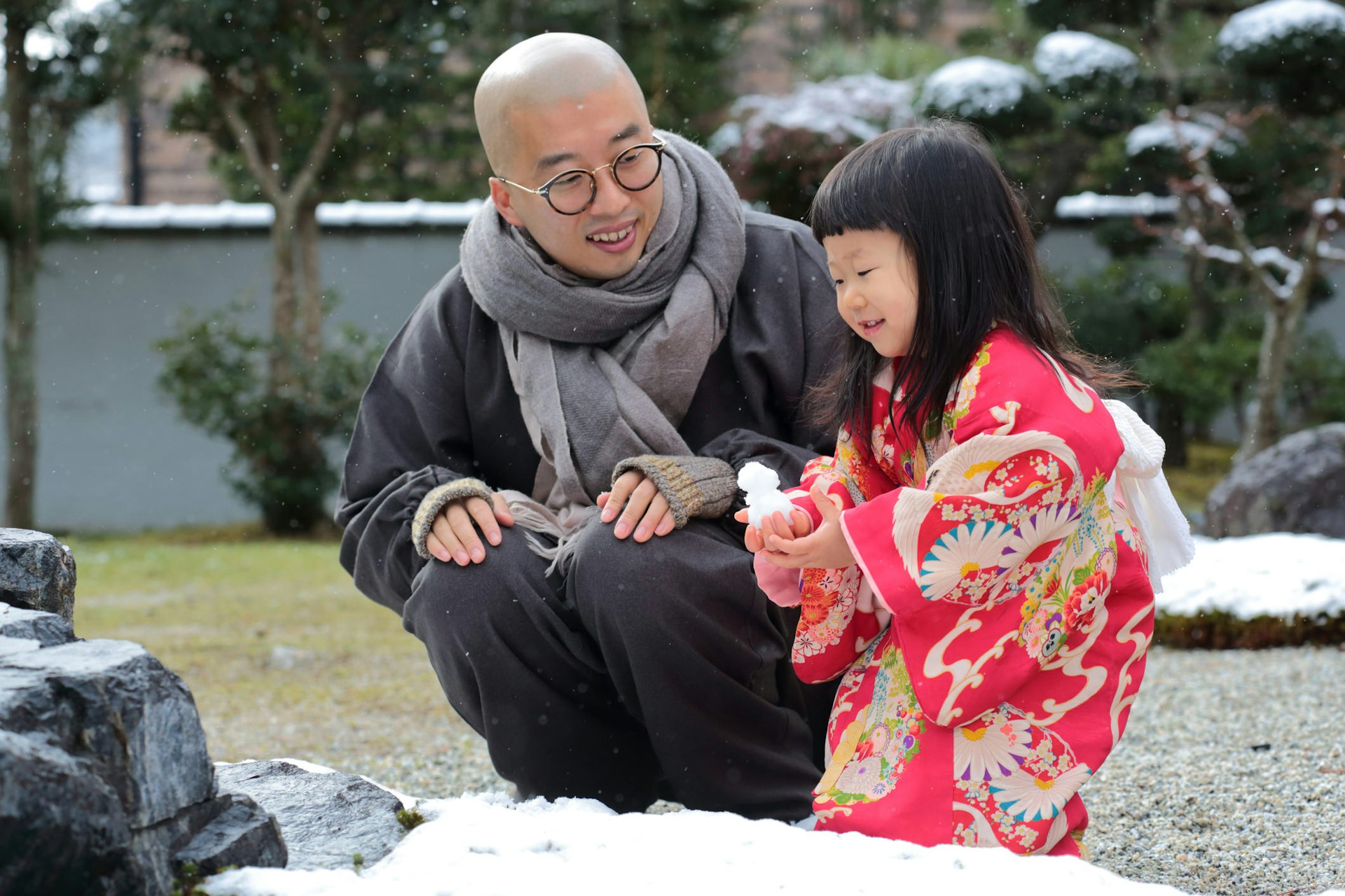 Father and daughter playing with snow in Kyoto, Japan