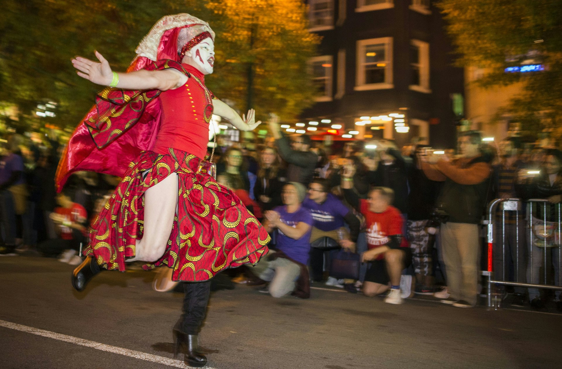 A person dressed in drag runs to the finish line during the annual High Heel Drag Race near Dupont Circle in Washington, DC.