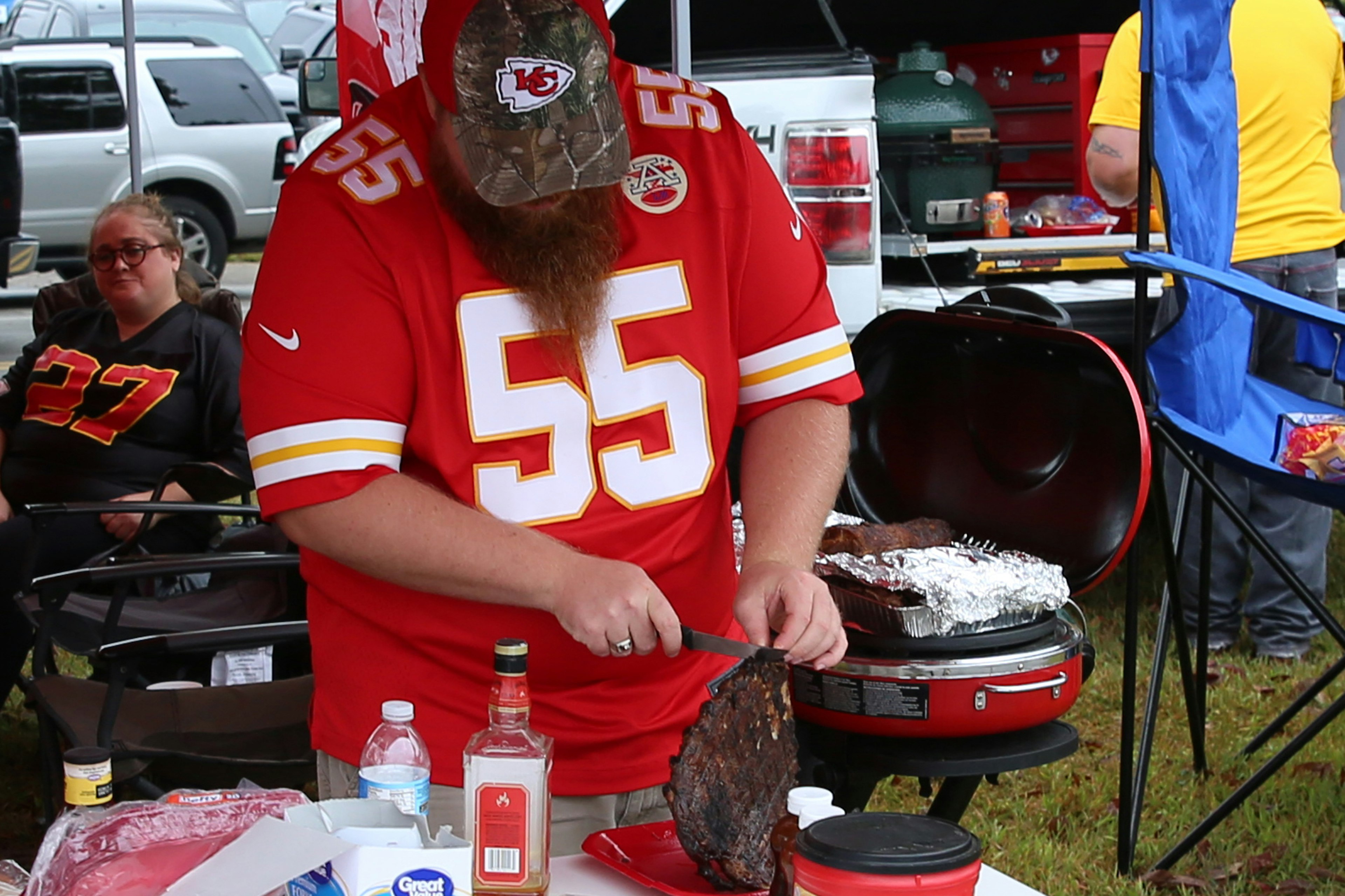 A Kansas City Chiefs fan prepares BBQ ribs during a tailgate in Kansas City, MO.