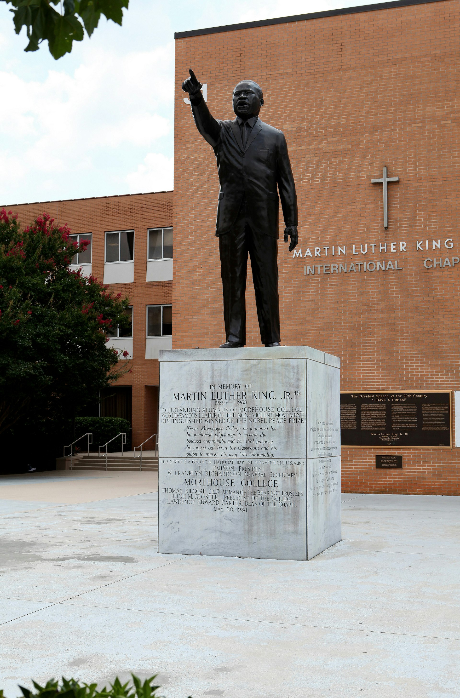 A statue of Dr. Martin Luther King Jr. stands in front of the Martin Luther King Jr. International Chapel at Morehouse College.
