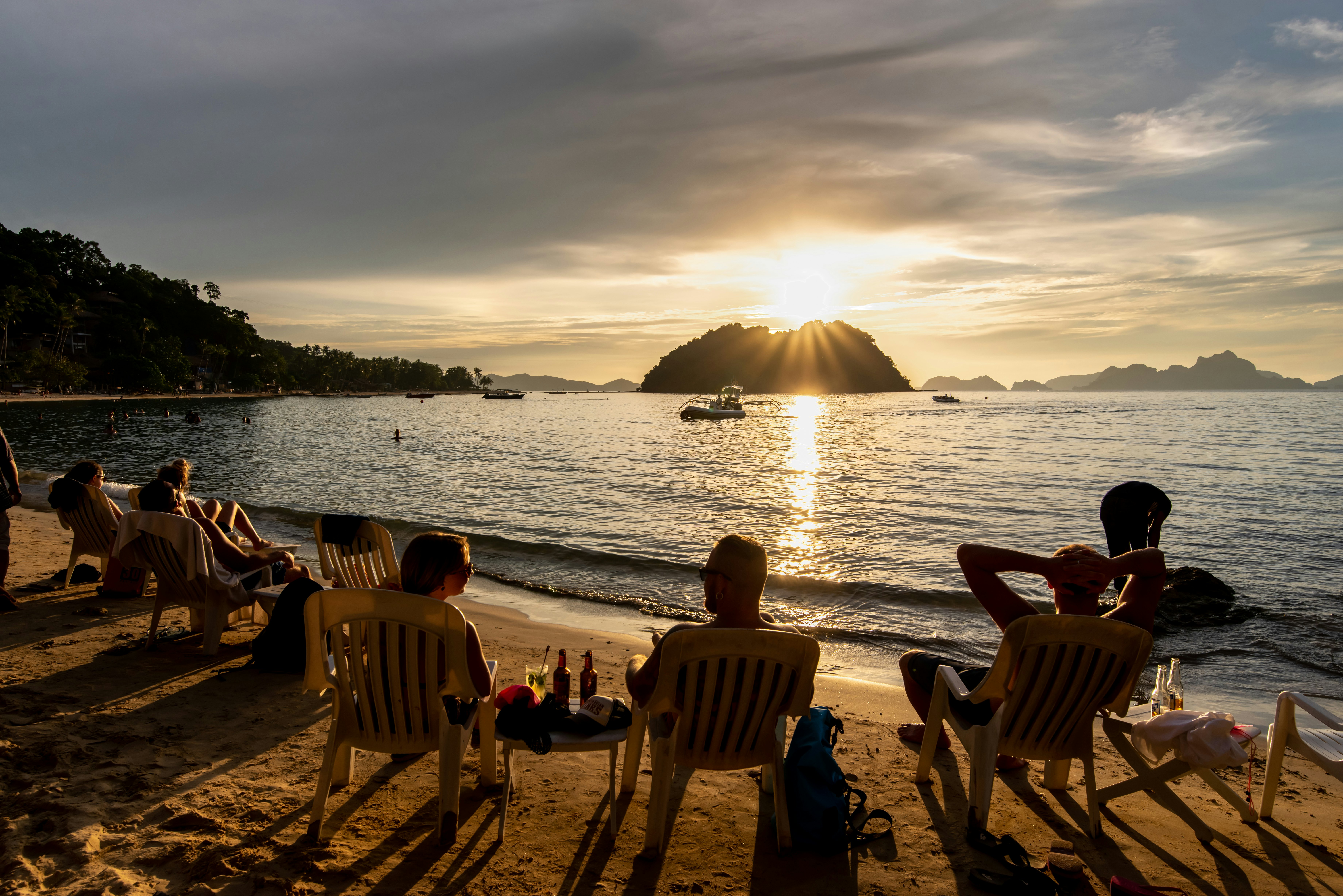 People watching the sunset on the Maremegmeg beach at El Nido, Palawan, Philippines.
