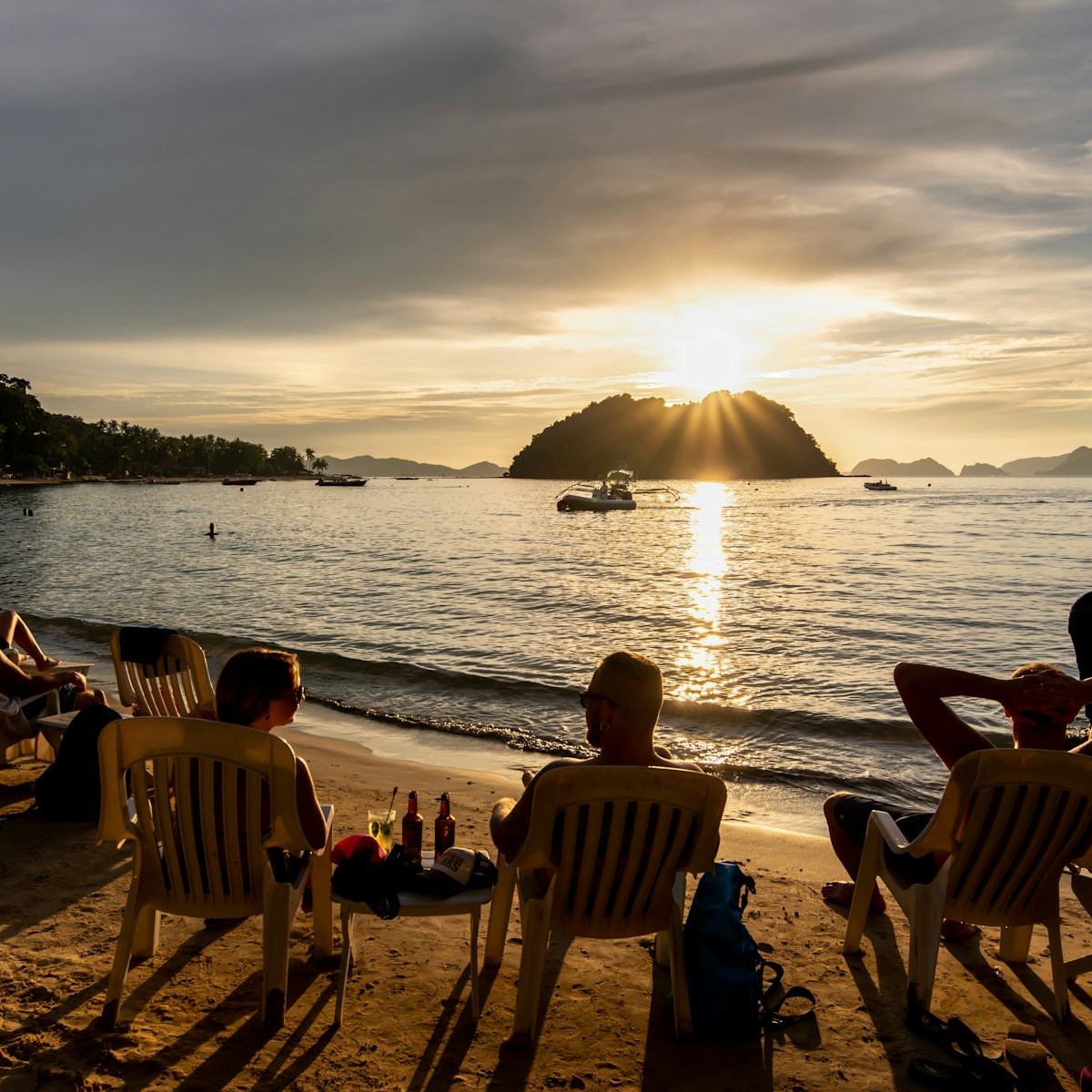 People watching the sunset on the Maremegmeg beach at El Nido, Palawan, Philippines.