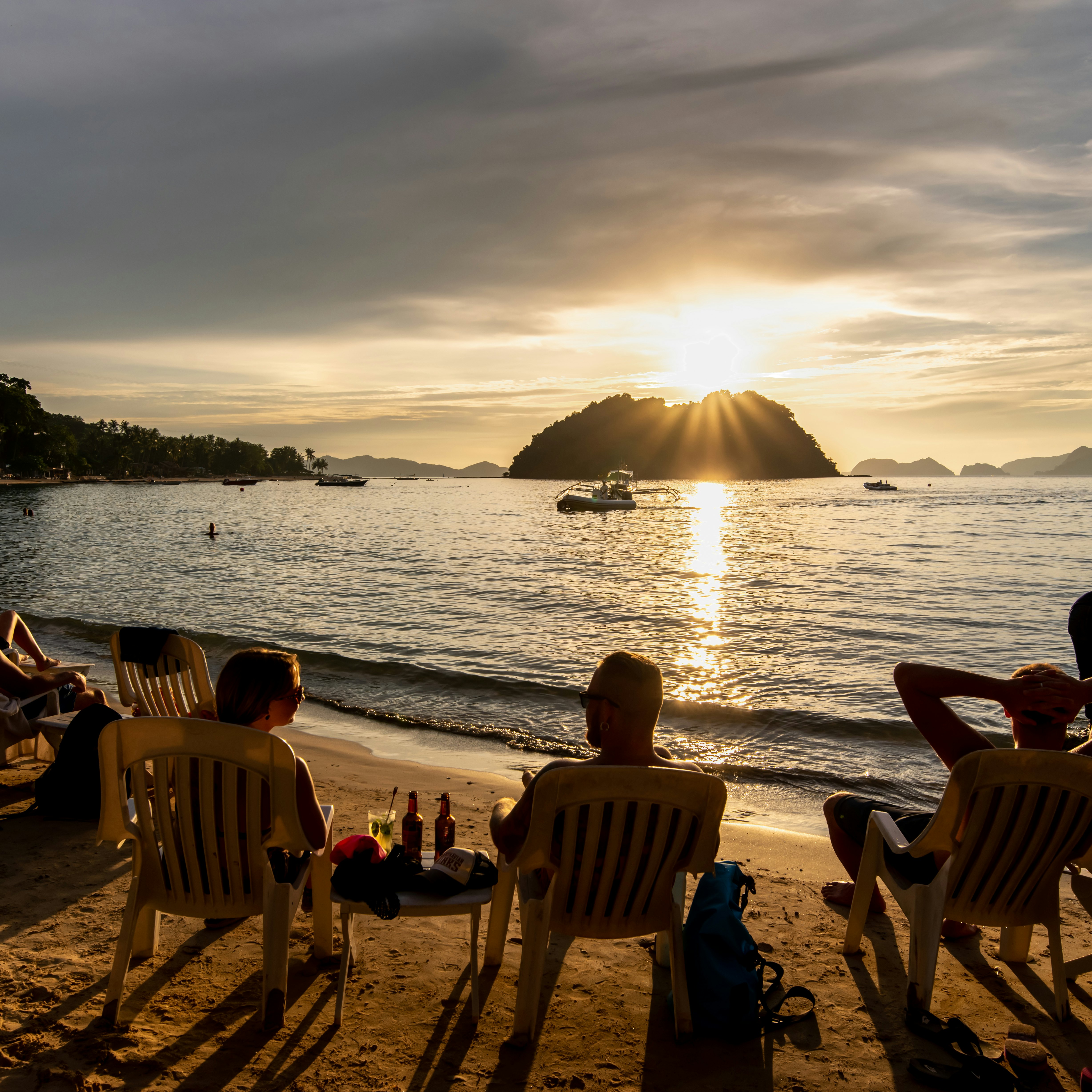 People watching the sunset on the Maremegmeg beach at El Nido, Palawan, Philippines.