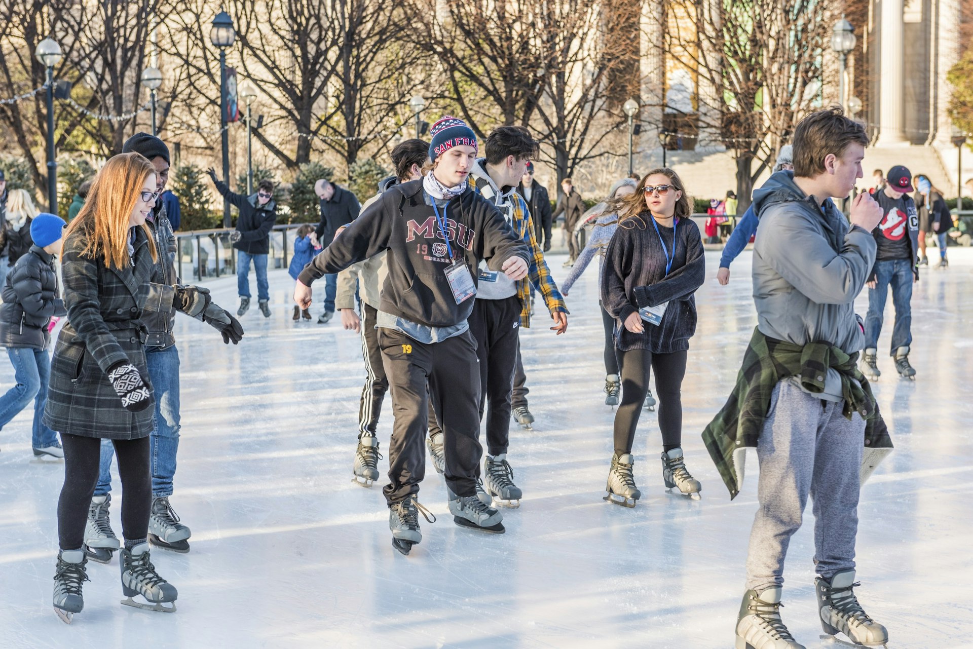 People skate on an ice rink in National Gallery of Art Sculpture garden in Washington, DC.