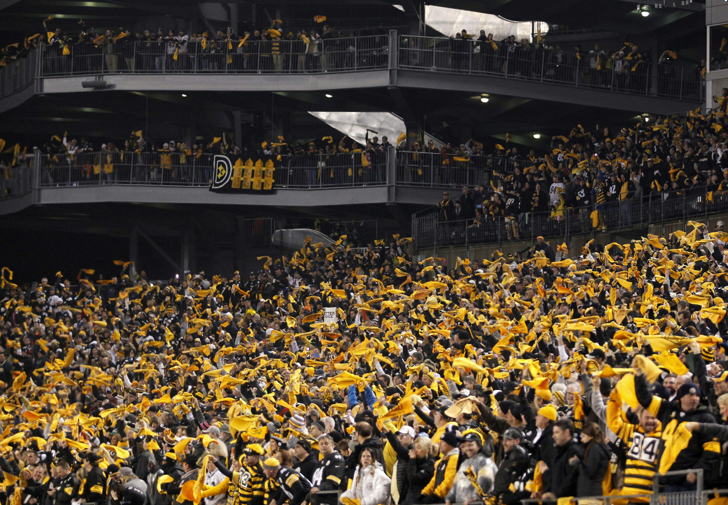 A stadium filled with Steeler fans wave their terrible towels during an NFL football game at Heinz Field in Pittsburgh, Pennsylvania.