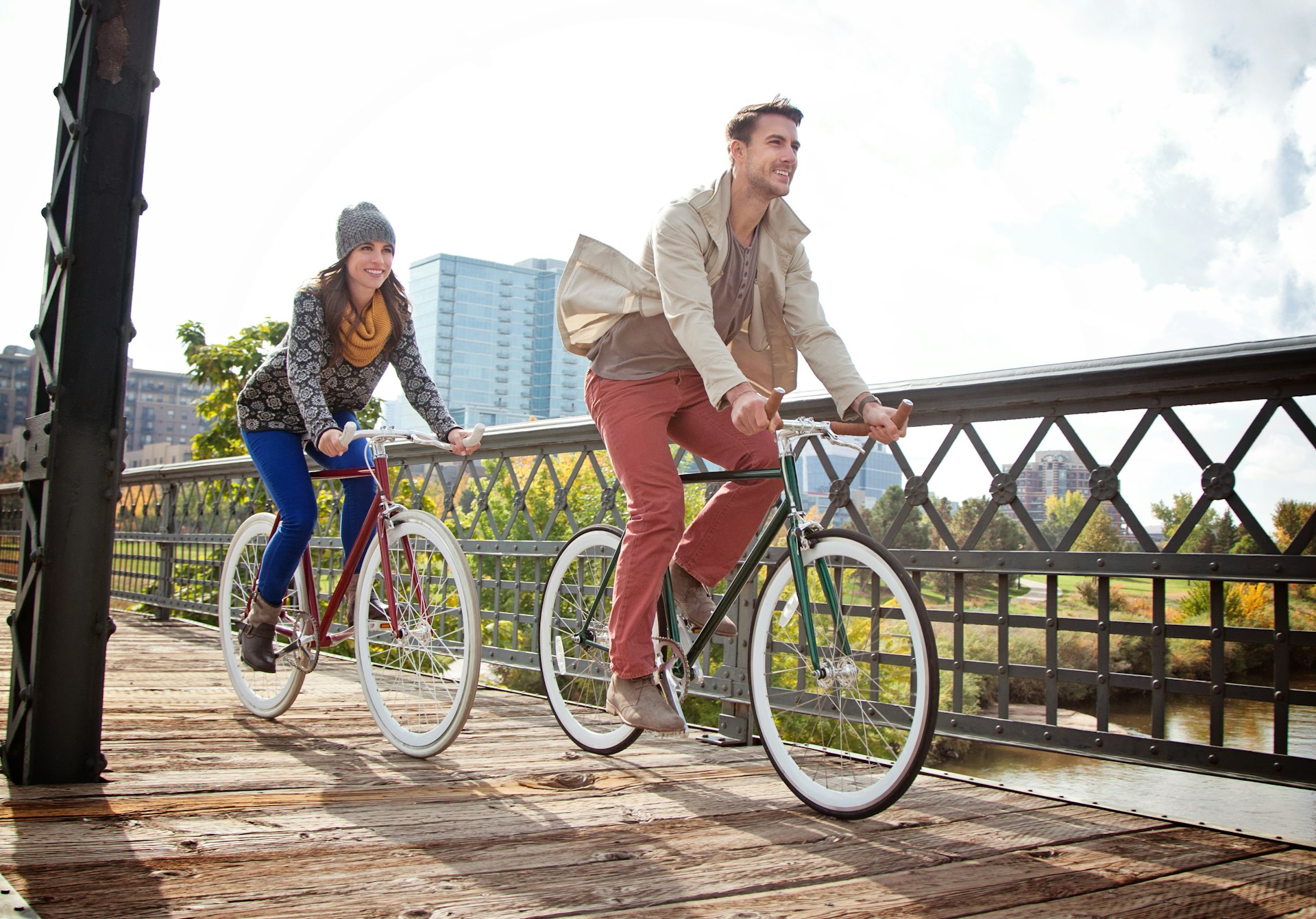 Young couple with urban bicycle in city park in Denver.