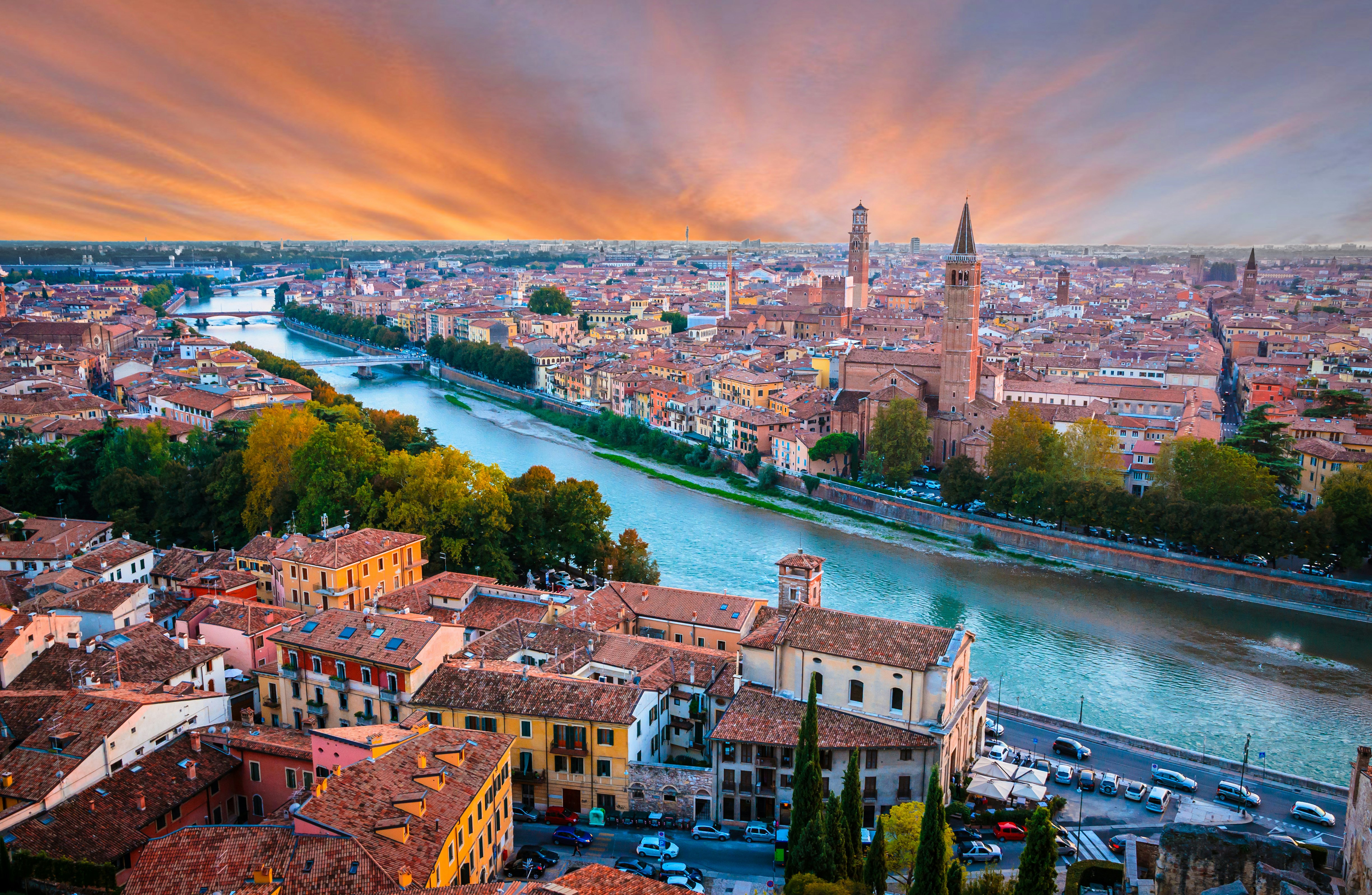 An aerial shot of a river running through the center of a medieval city