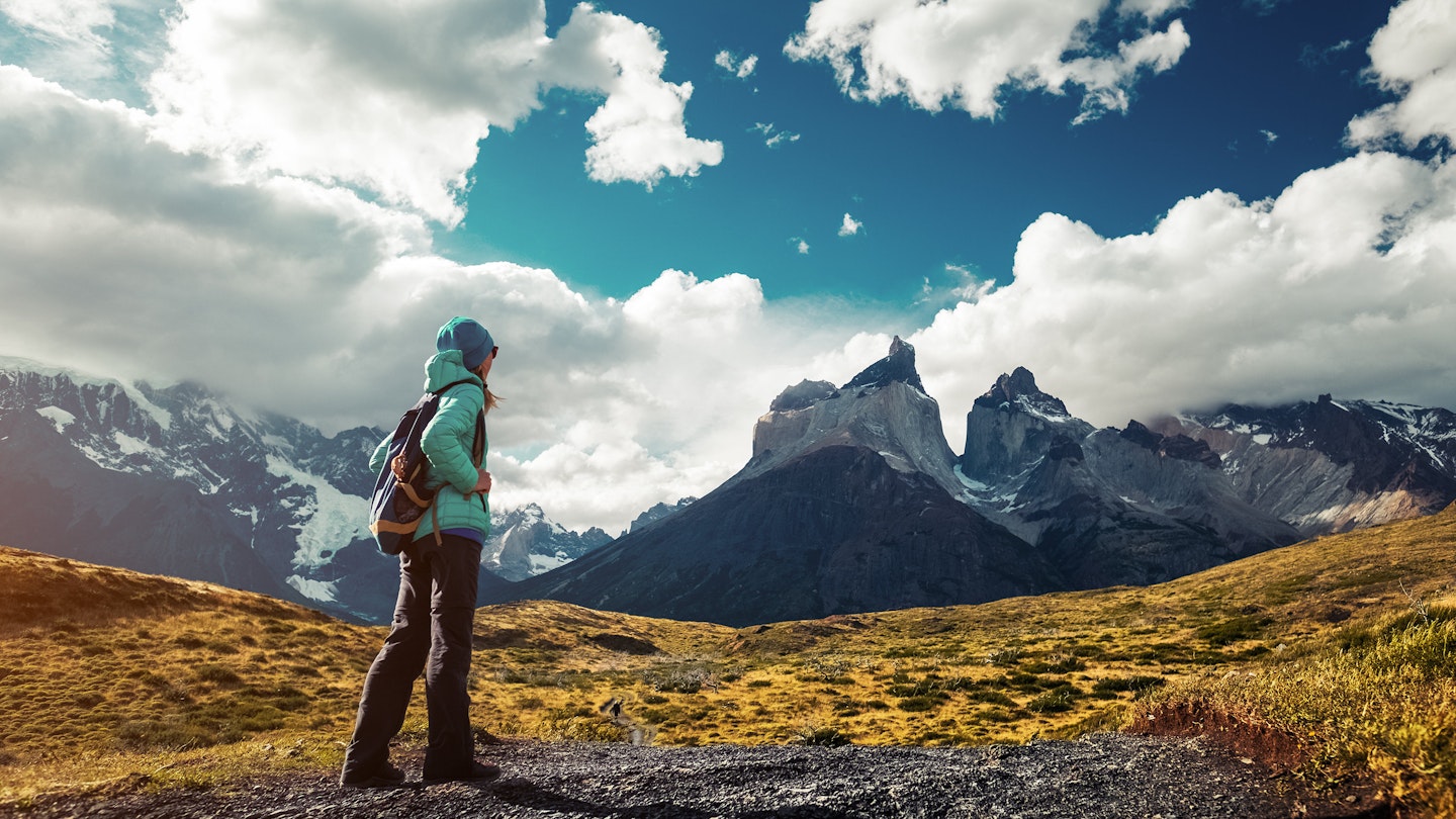A female hiker on a trail at Torres del Paine National Park.