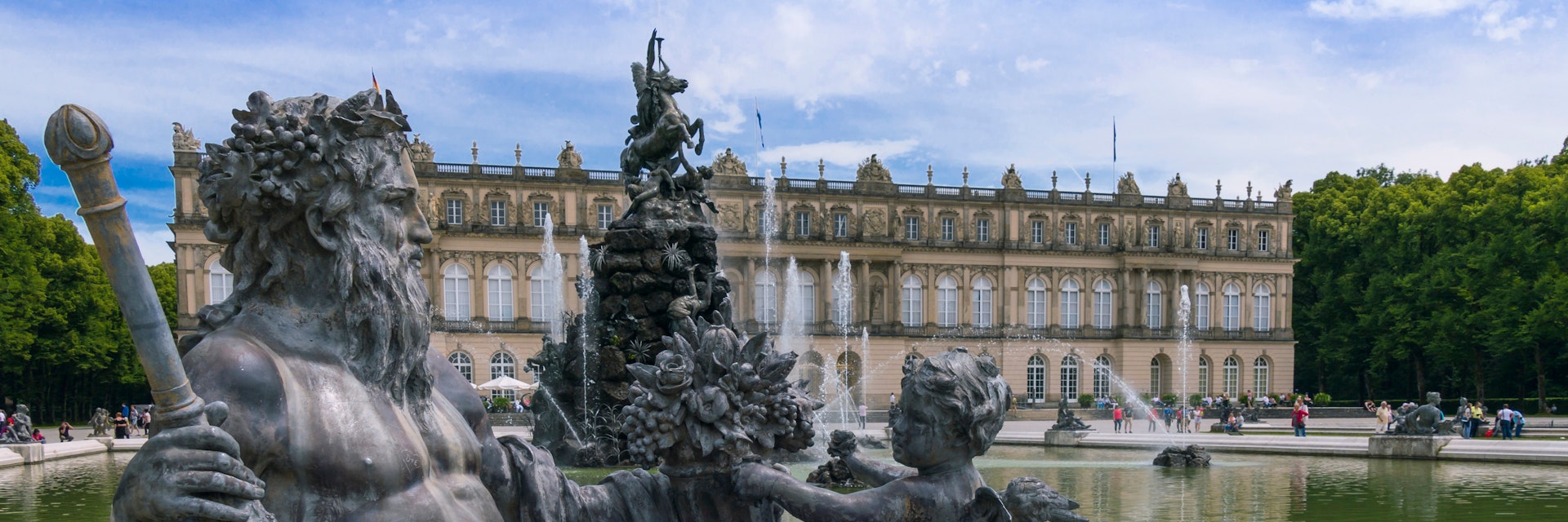 June 25, 2015: Sculptures and a fountain in the castle gardens of Herrenchiemsee New Palace.