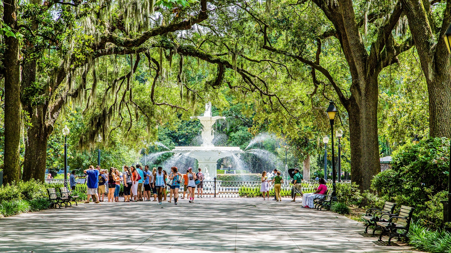 SAVANNAH, GEORGIA - June 7, 2014:  Park fountain with tourists in Savannah, Georgia.