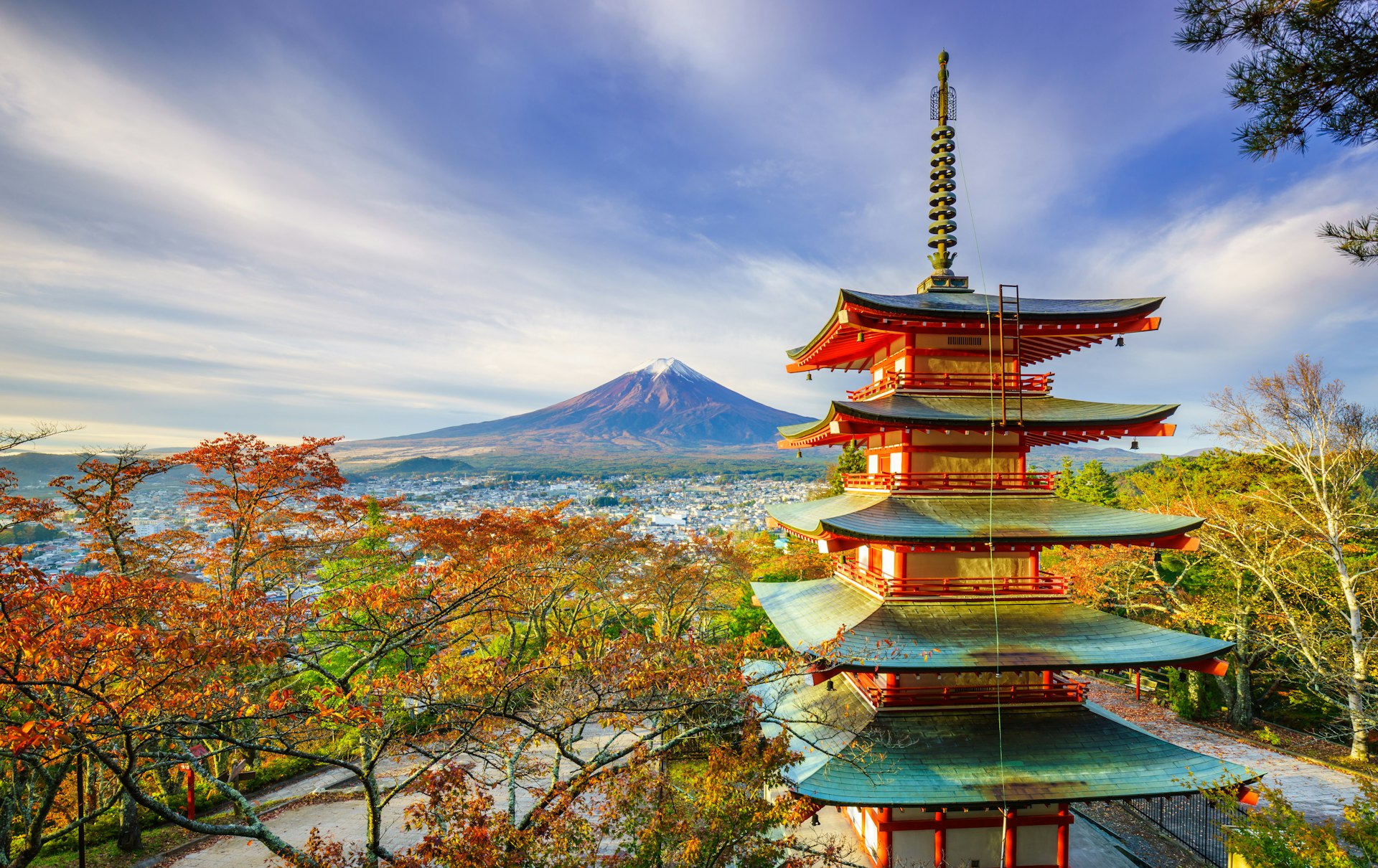 Mt. Fuji with Chureito Pagoda at sunrise and surrounded by autumn leaves. 