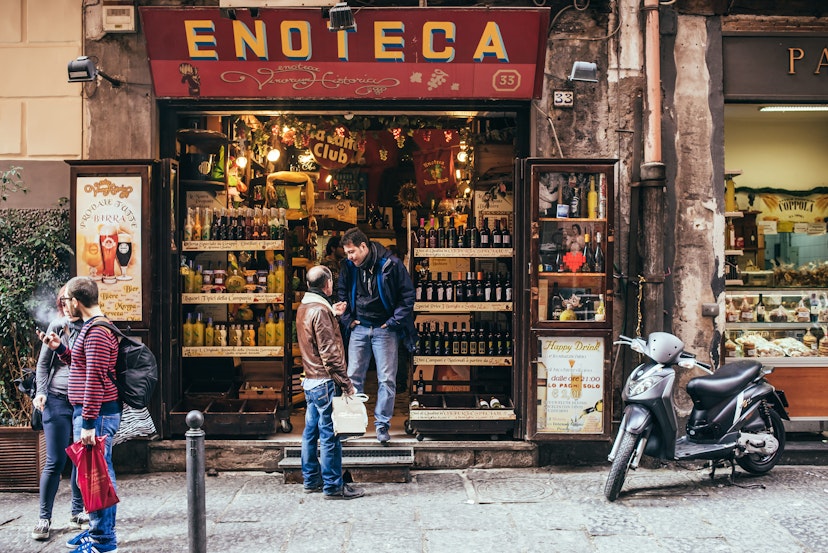 NAPLES, ITALY - MARCH 20, 2015:  Range of the wine shop on the old popular street in Naples, Italy
