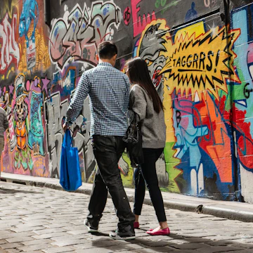 Melbourne, Australia - March 22, 2014: people walking past graffiti wall in Hosier Lane in Melbourne
