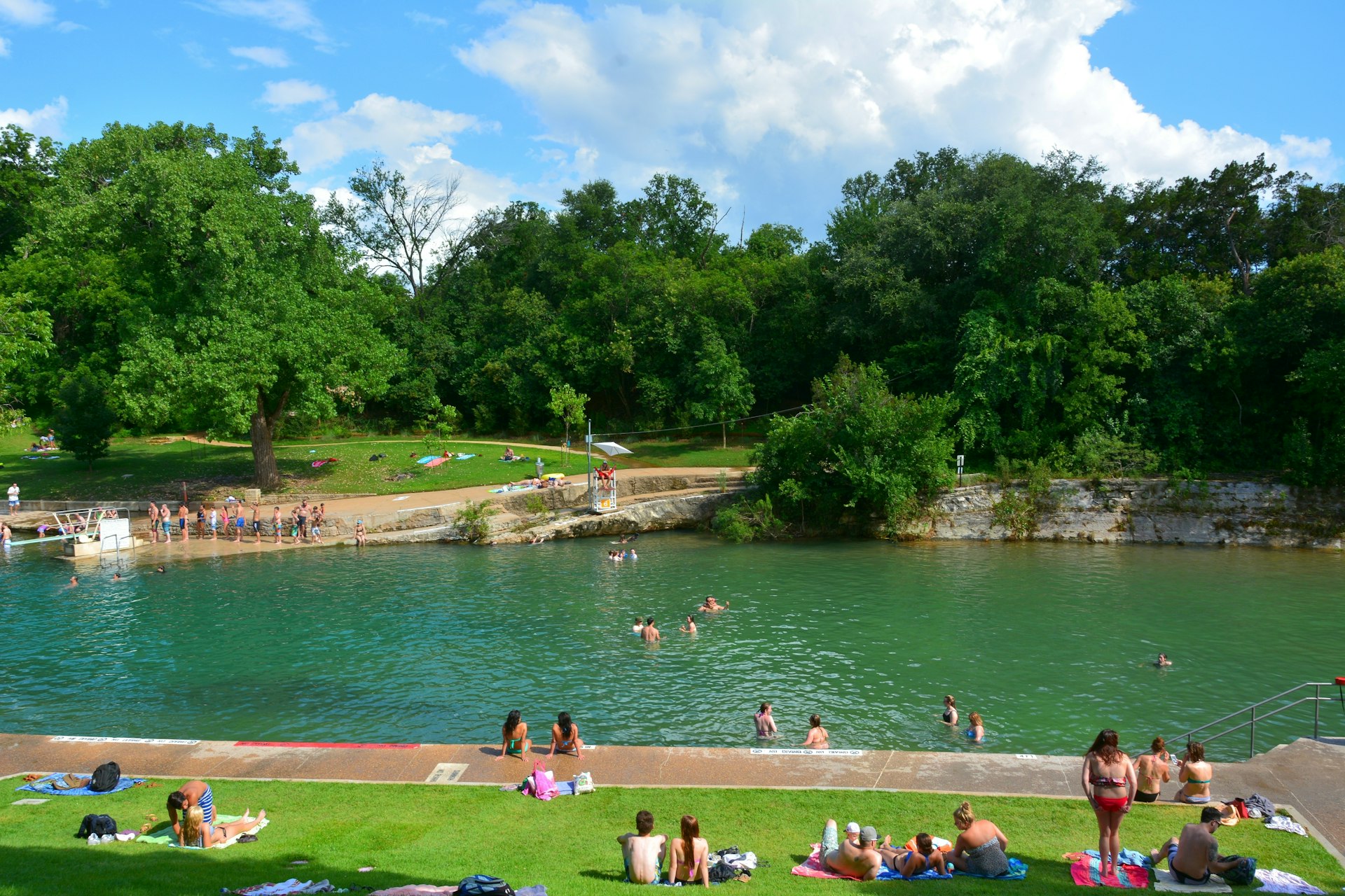 People playing in the water at Barton Springs Pool in Zilker Park, Austin