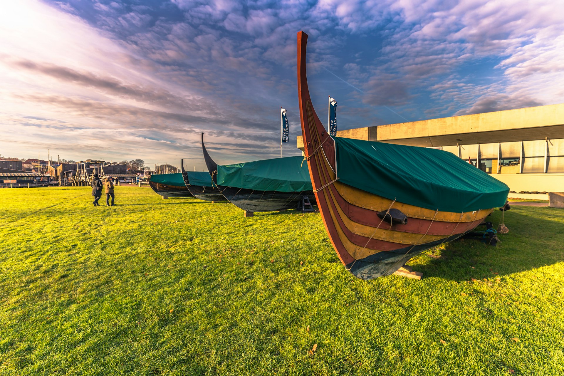 Replicas of Viking longboats sit on the grass outside the museum
