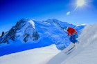 Man skiing down a steep slope in the Chamonix Valley.