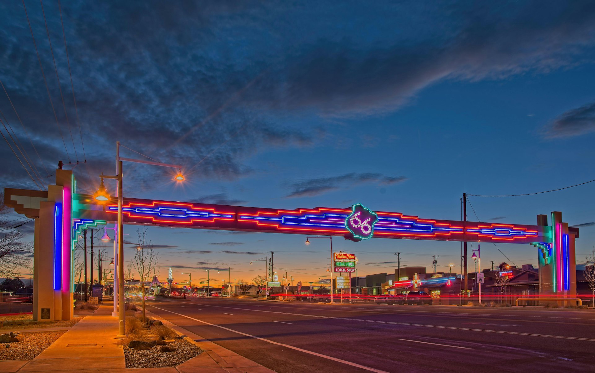Neon Route 66 sign over Central Ave., (Route 66) Albuquerque, New Mexico, looking West at sunset.  It was also called the Will Rogers Highway.