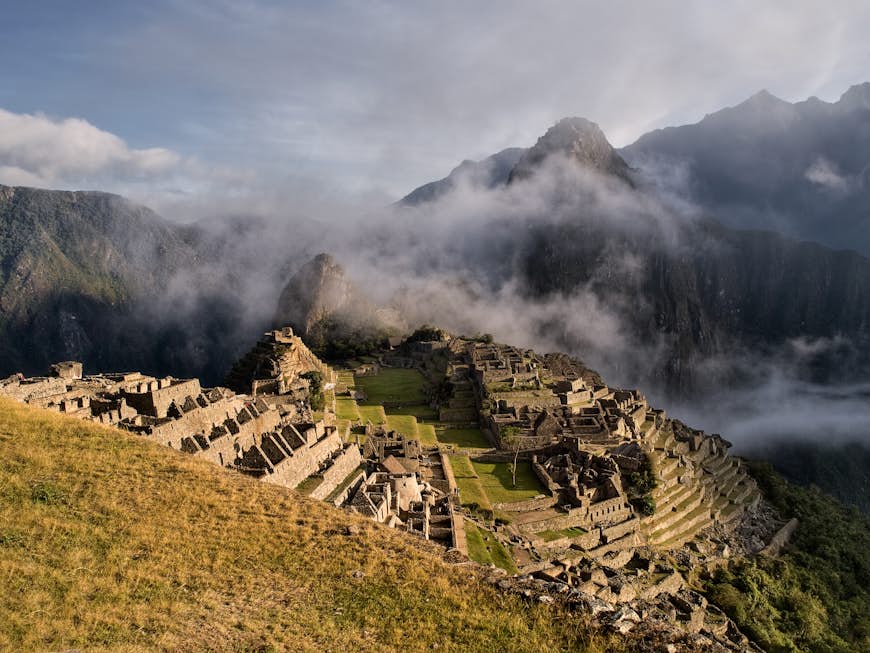 Machu Picchu is cloaked in fog.