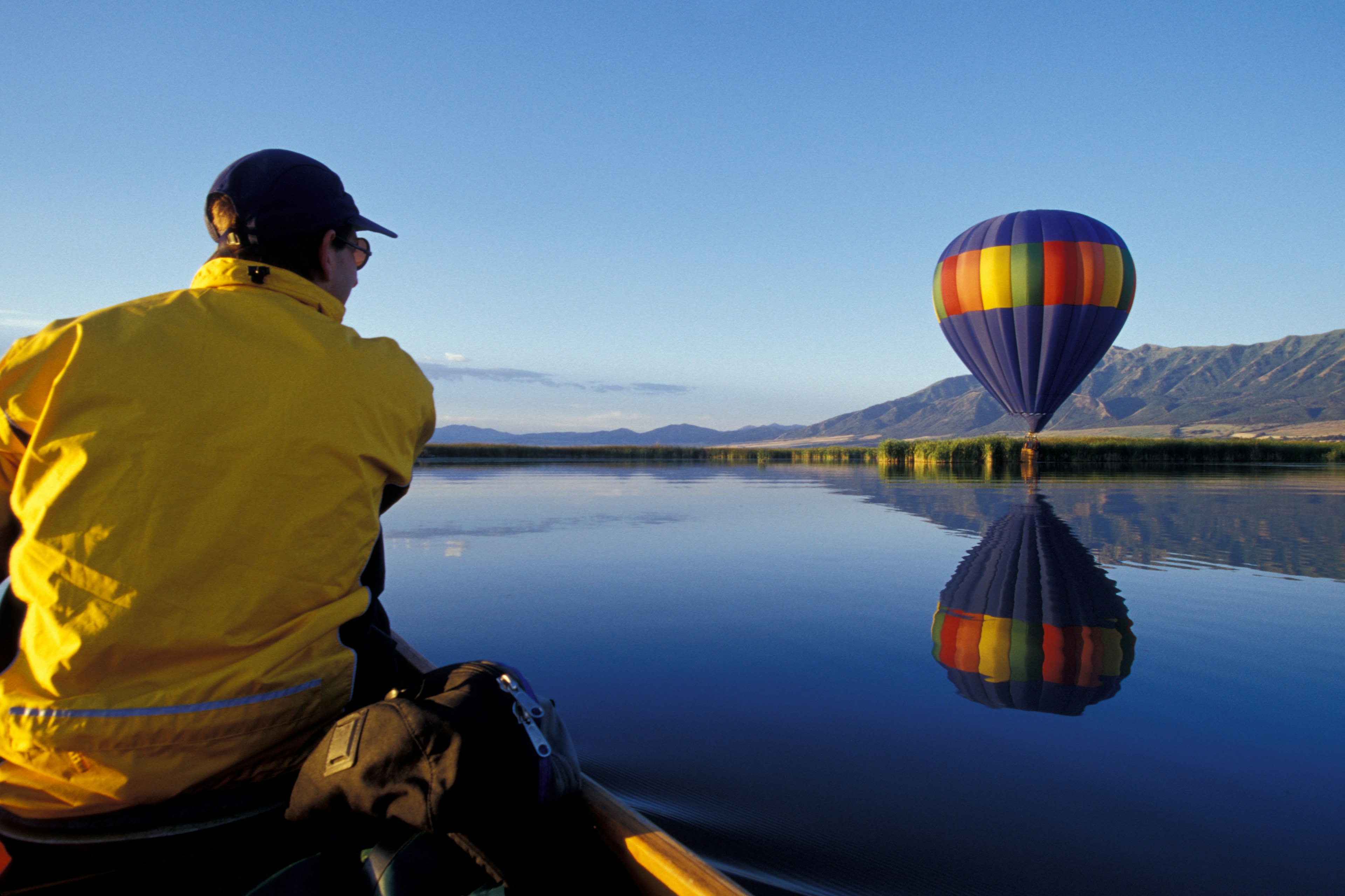 North America, USA, Utah, Cache Valley, Logan River Marshes at sunrise. Hot air balloon and canoe in pursuit  (MR)