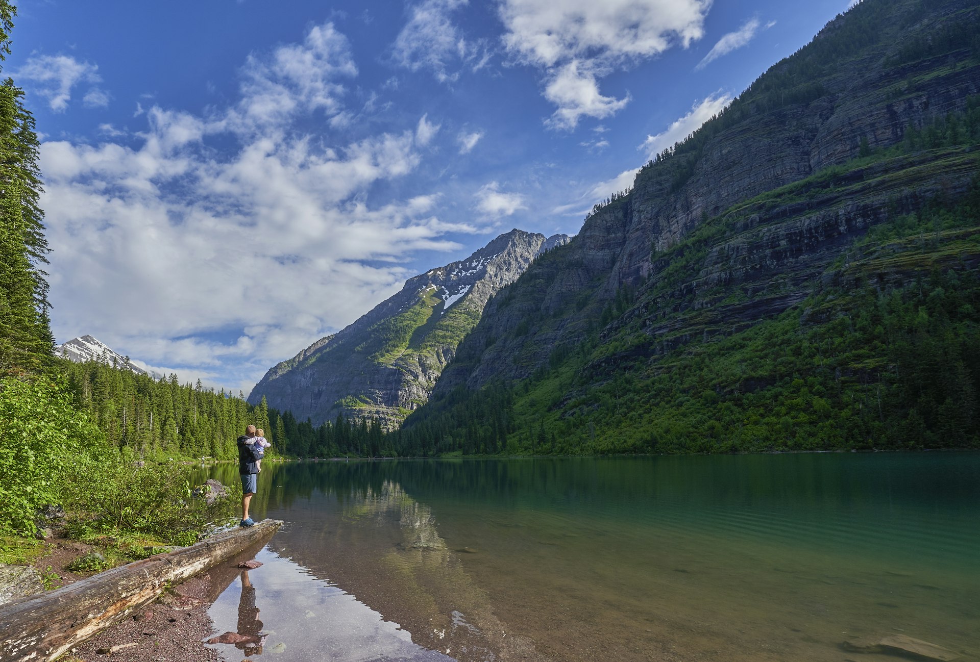 Family on the shore of Avalanche Lake in Glacier National Park