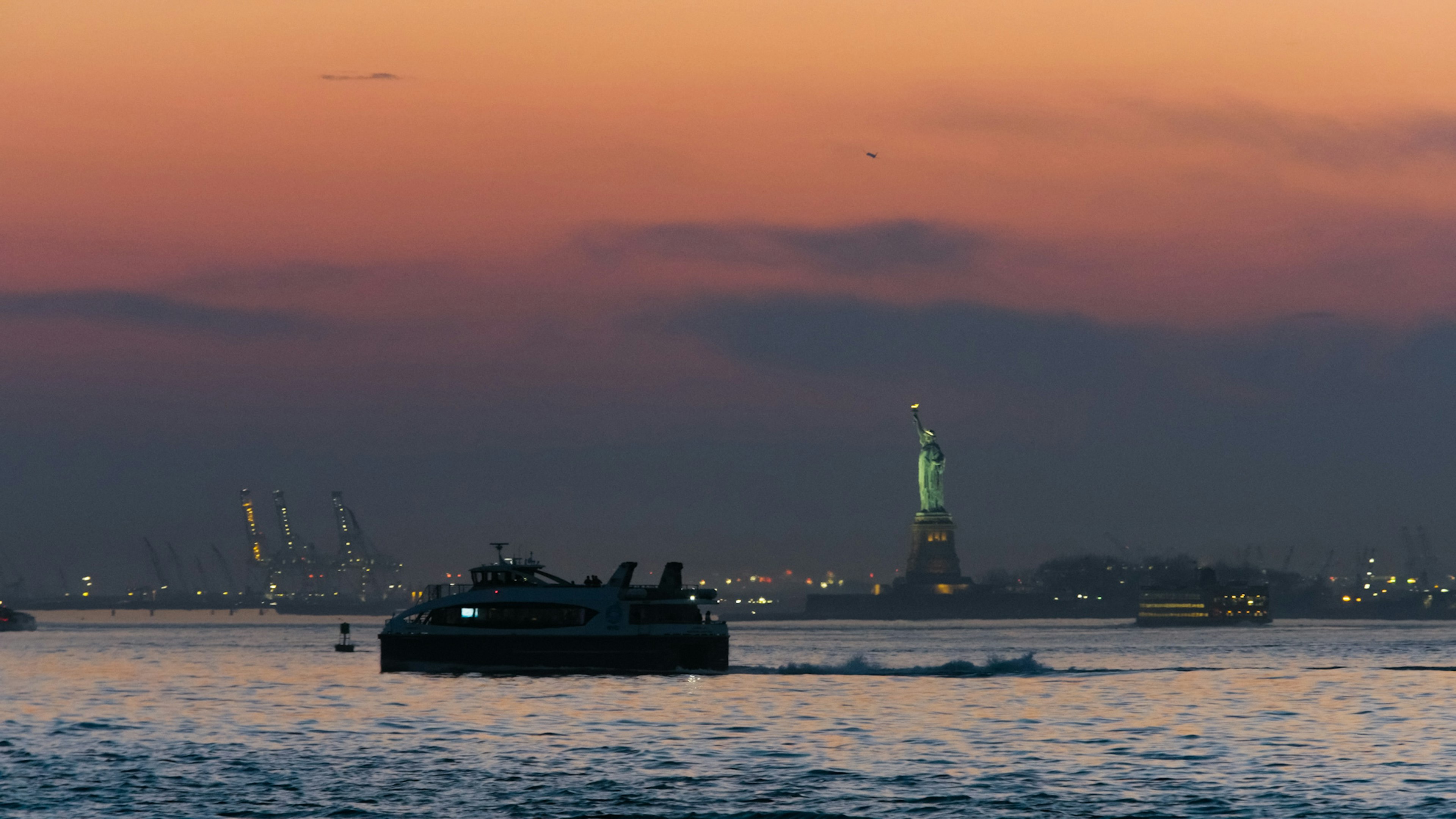 Sunset view of the Statue of Liberty from the East River