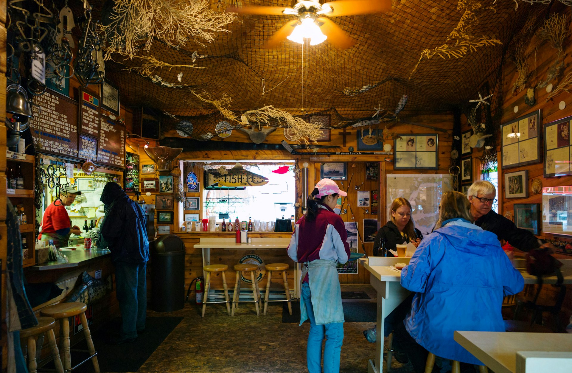 Visitors dining inside the Swiftwater Seafood Cafe, Whittier, Alaska, USA