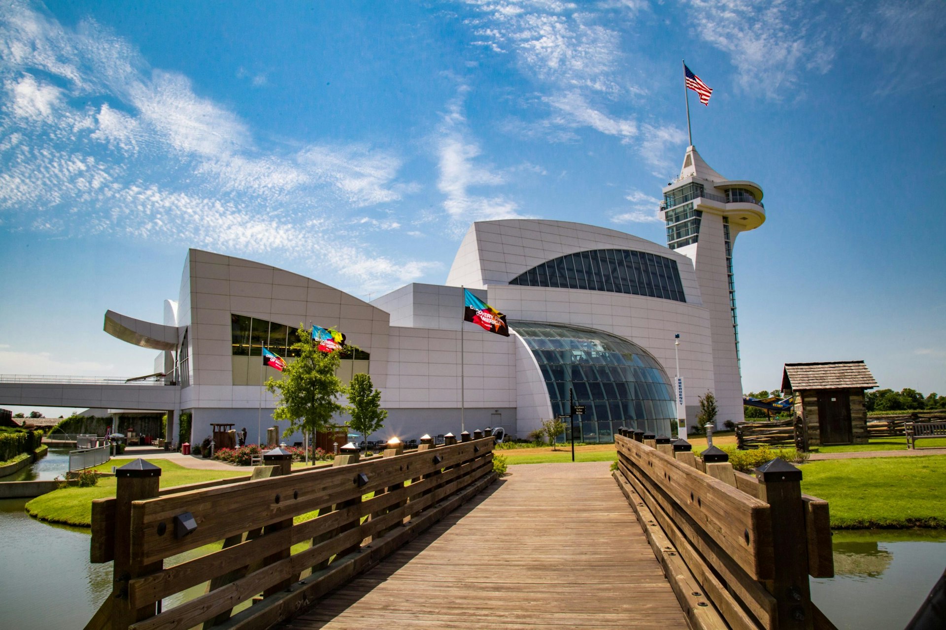 Exterior shot of the large white building of the Discovery Center at the Discovery Park of America