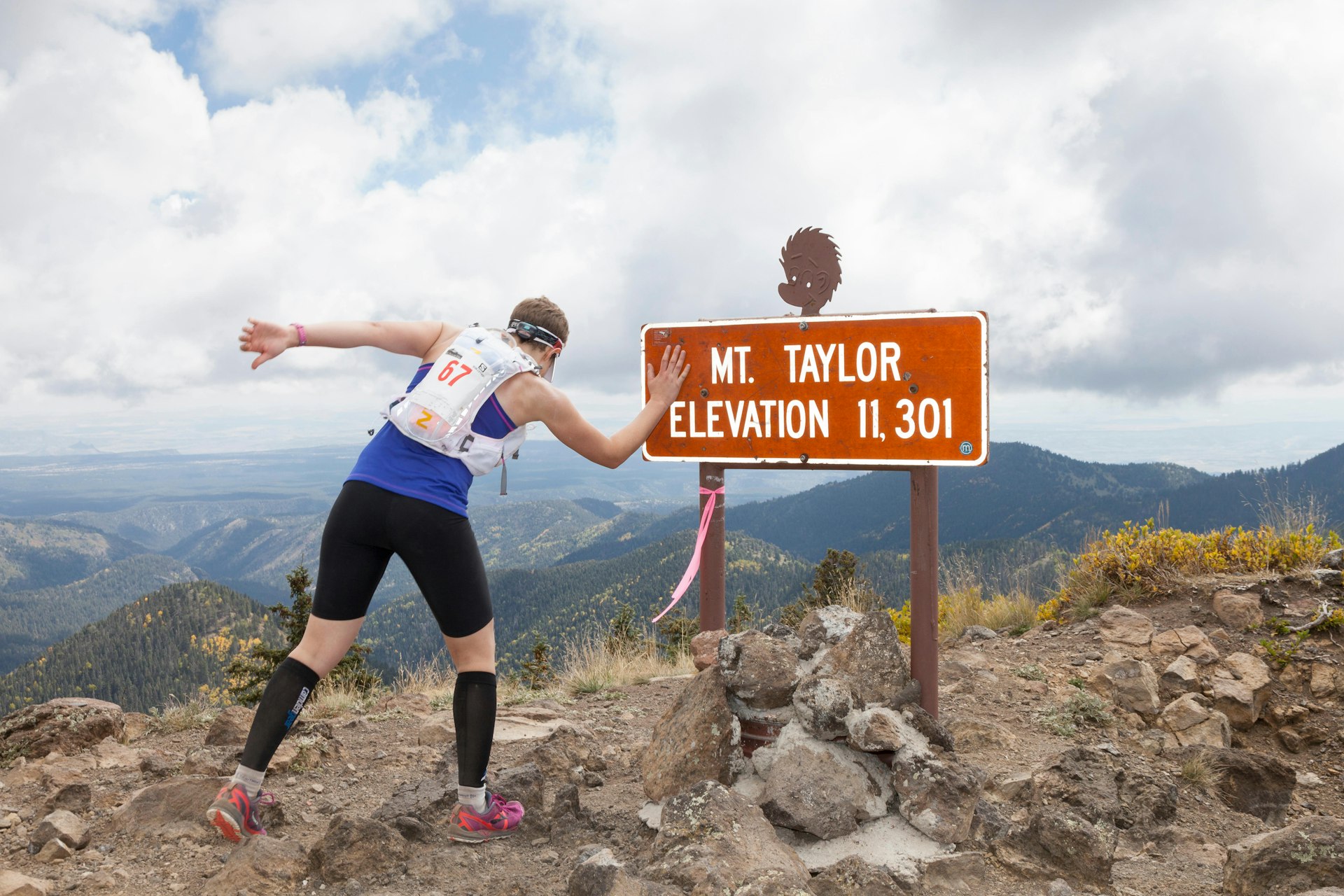 Runner reaches the summit during the Mt Taylor 50k - Mt Taylor, San Mateo Mountains, Cibola National Forest, New Mexico, USA