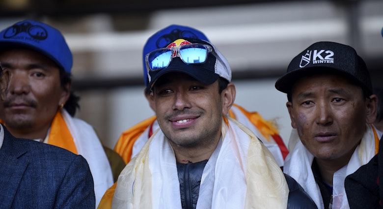 Nirmal Purja along the team member of Nepalese mountaineering team arrive and greet towards people after the first to scale Mount K2 in winter cheer as they arrive at Tribhuwan International airport in Kathmandu, Nepal, Tuesday, January 26, 2021. (Photo by Narayan Maharjan/NurPhoto via Getty Images)