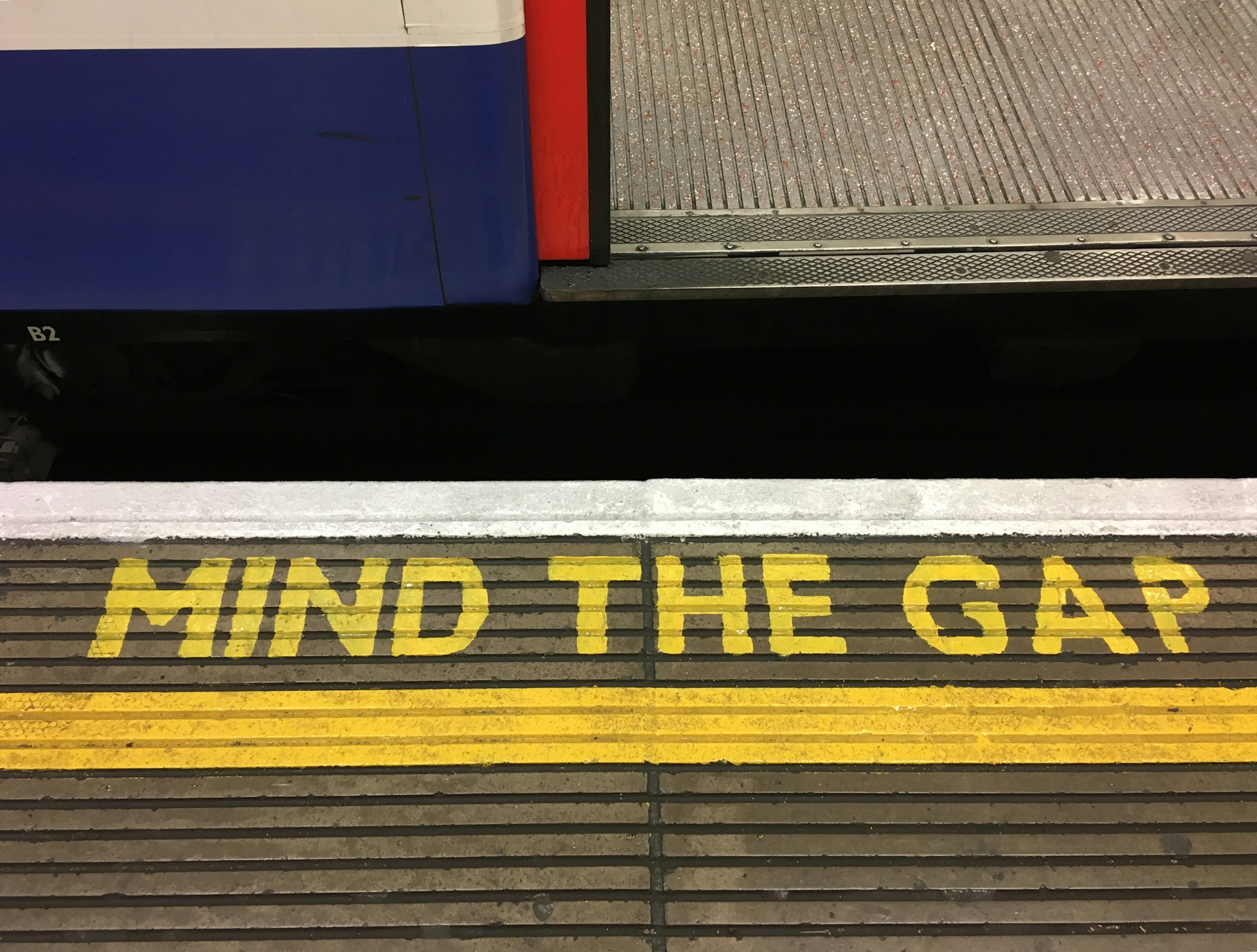 The "mind the gap" warning sign that is painted in yellow on the platforms of most London underground stations