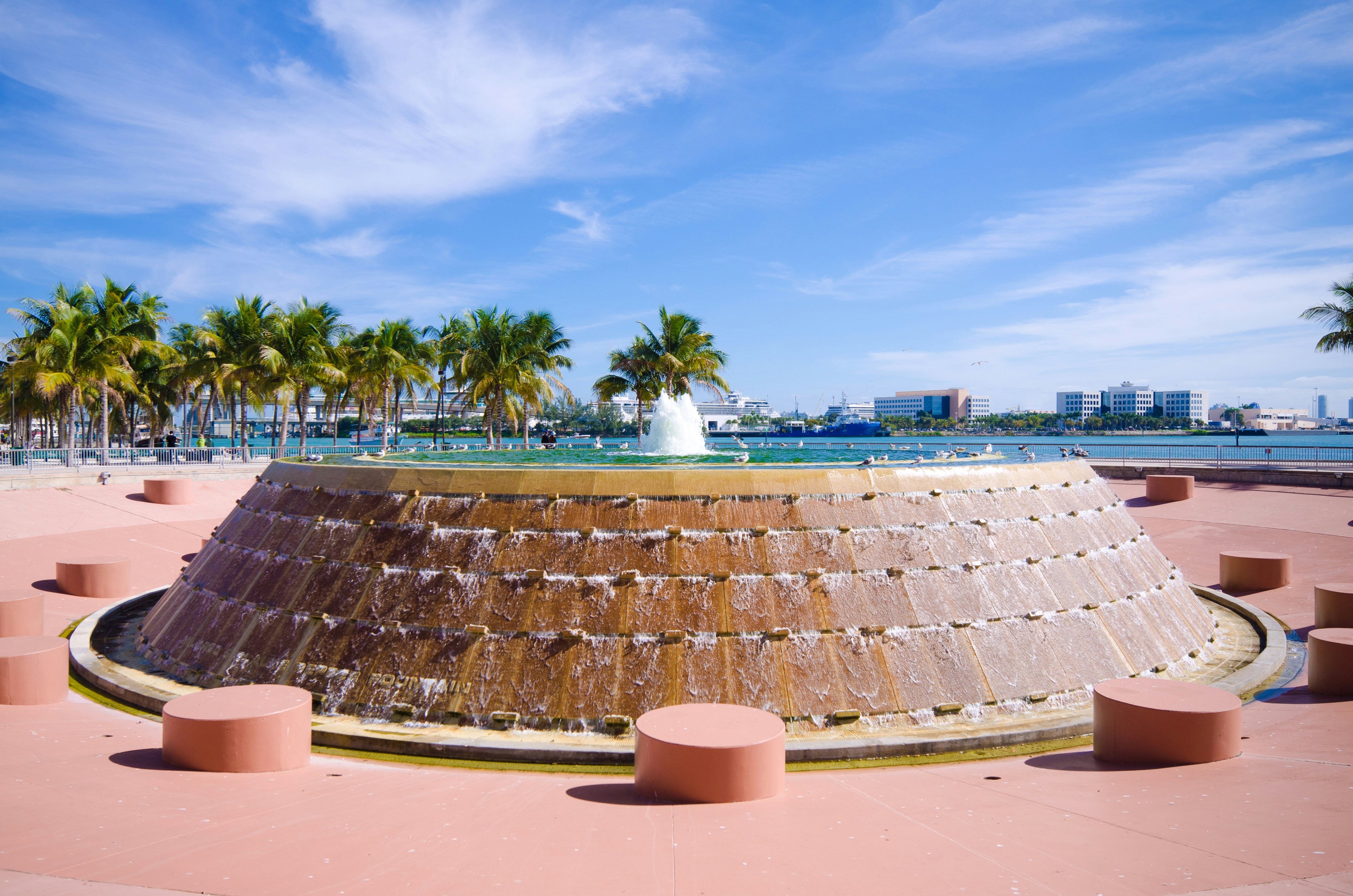 Fountain at Bayfront Park in the downtown area of Miami, FL with Biscayne Bay in the distance.