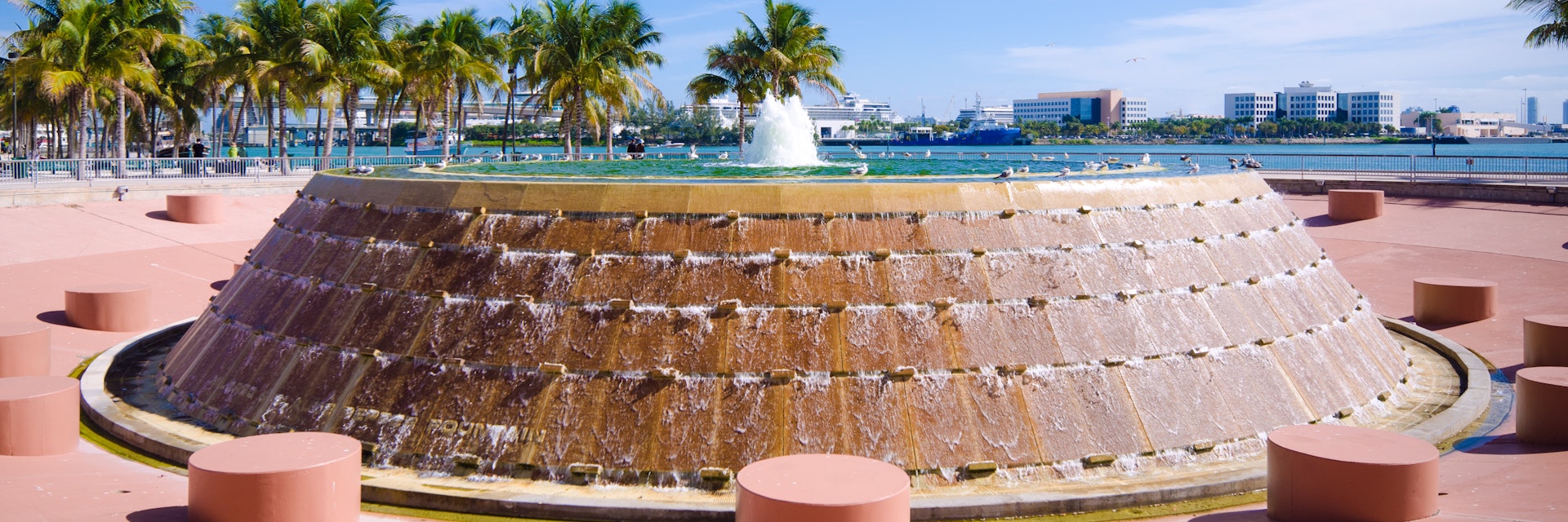 Fountain at Bayfront Park in the downtown area of Miami, FL with Biscayne Bay in the distance.