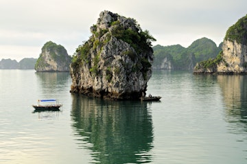 Small local boats and islets in Bai Tu Long.