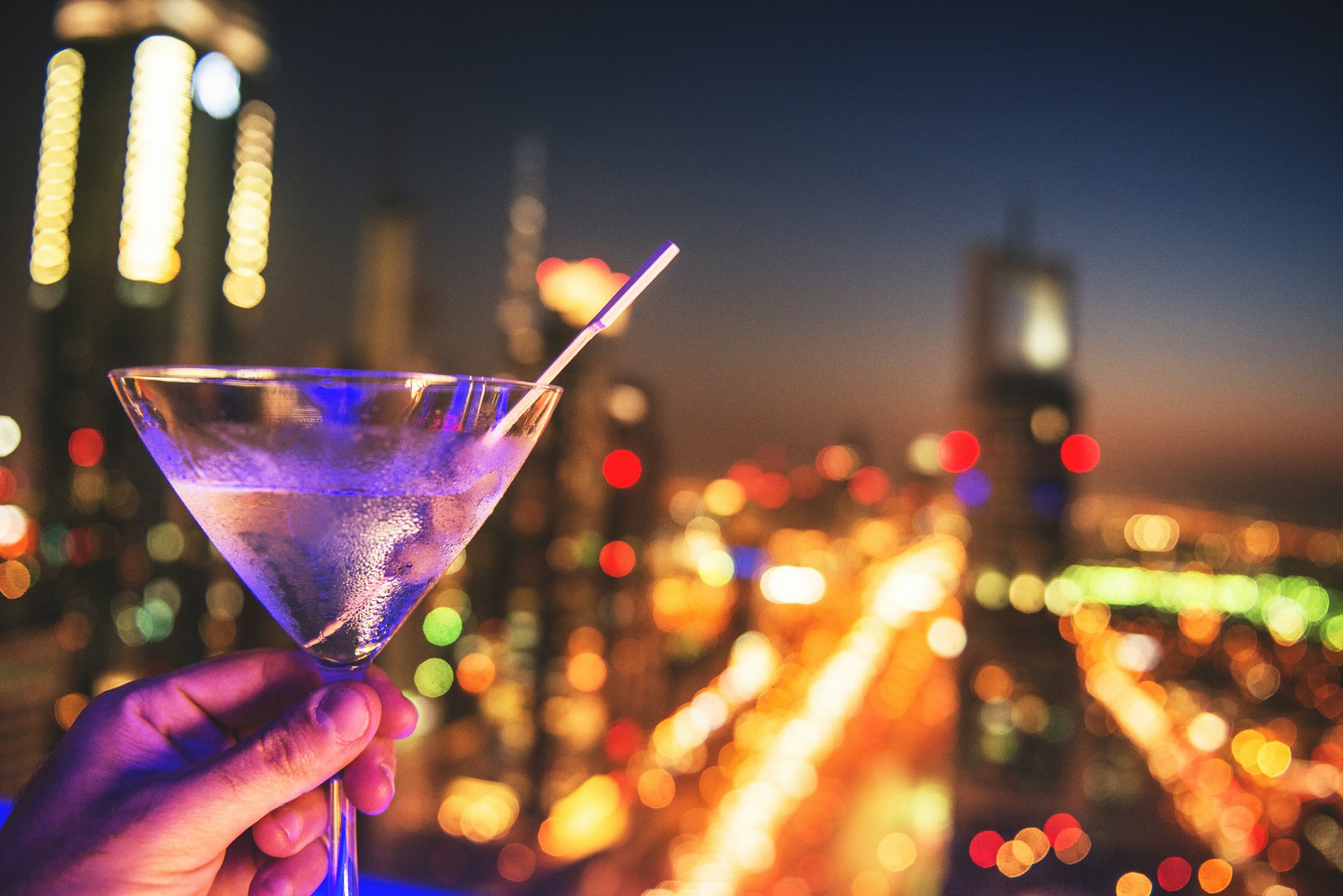 Martini glass with the lights of Dubai in the background