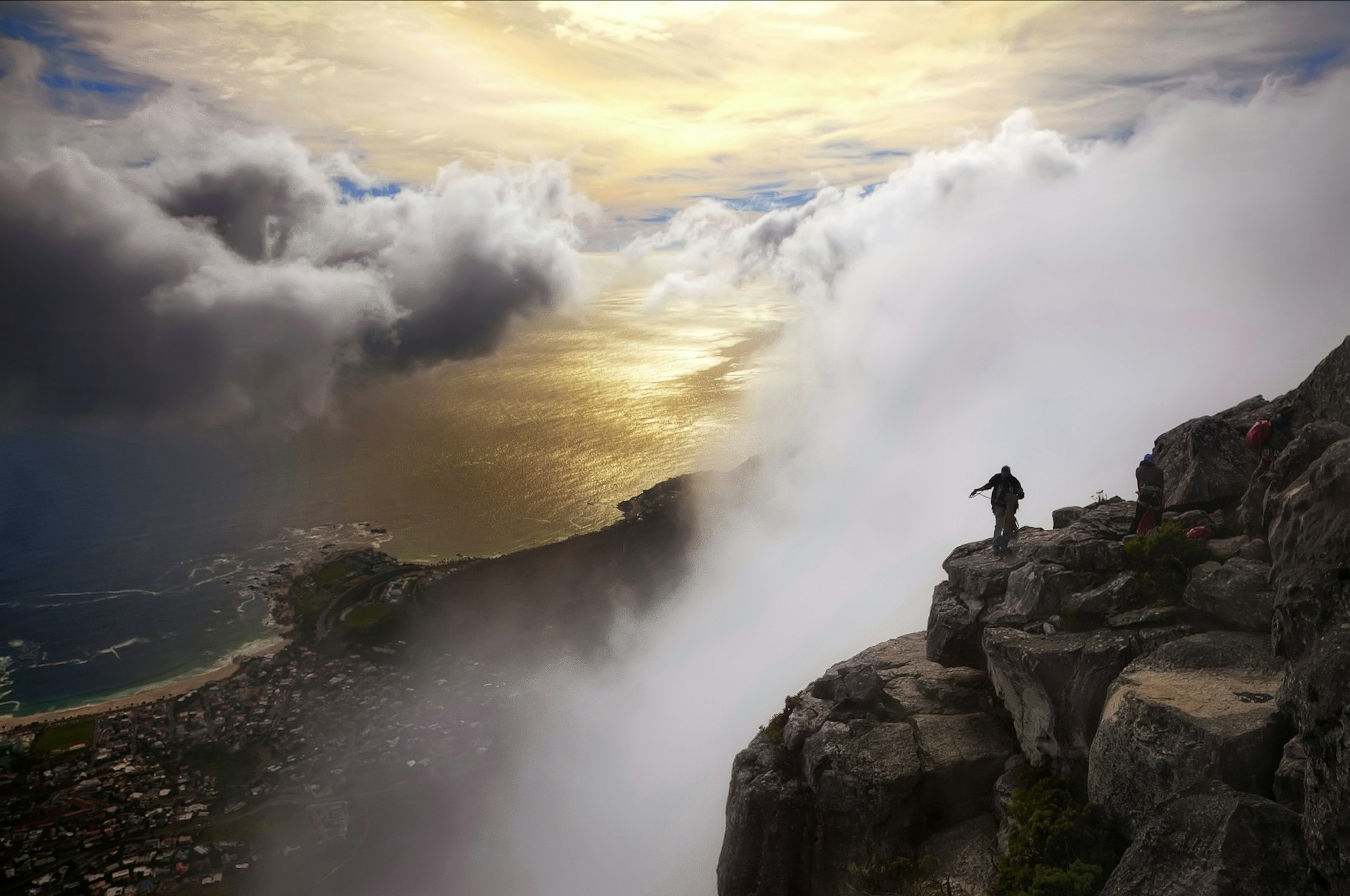 The View of Table Bay From Table Mountain, Cape Town, South Africa includes the sea, mist, houses and people