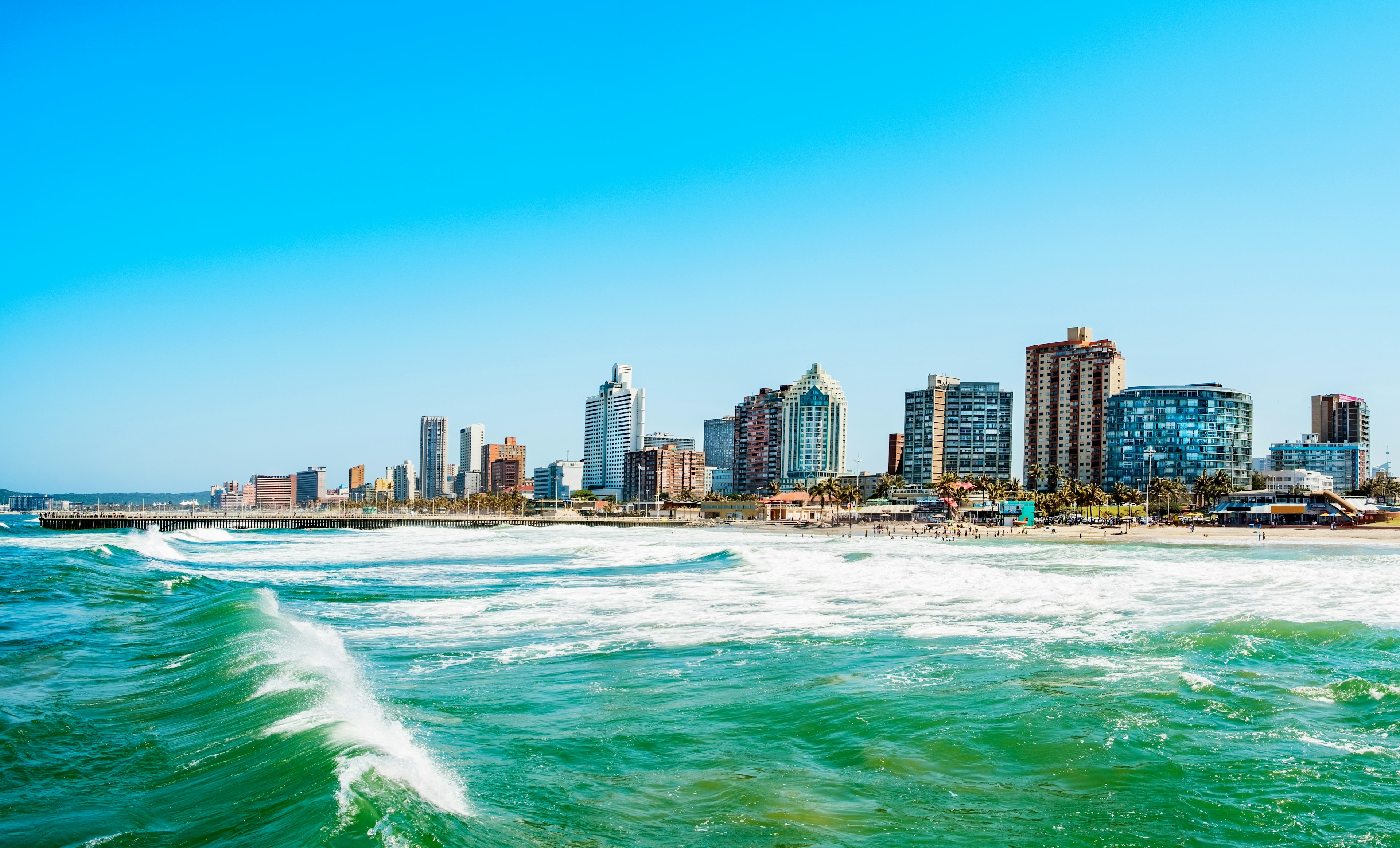 Sea waves with coastal high-rise in background, Durban.