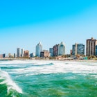 Sea waves with coastal high-rise in background, Durban.