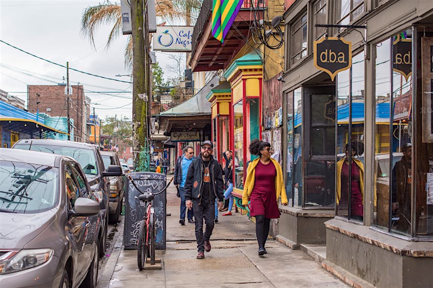 Stylish couple walks along Frenchman Street in New Orleans