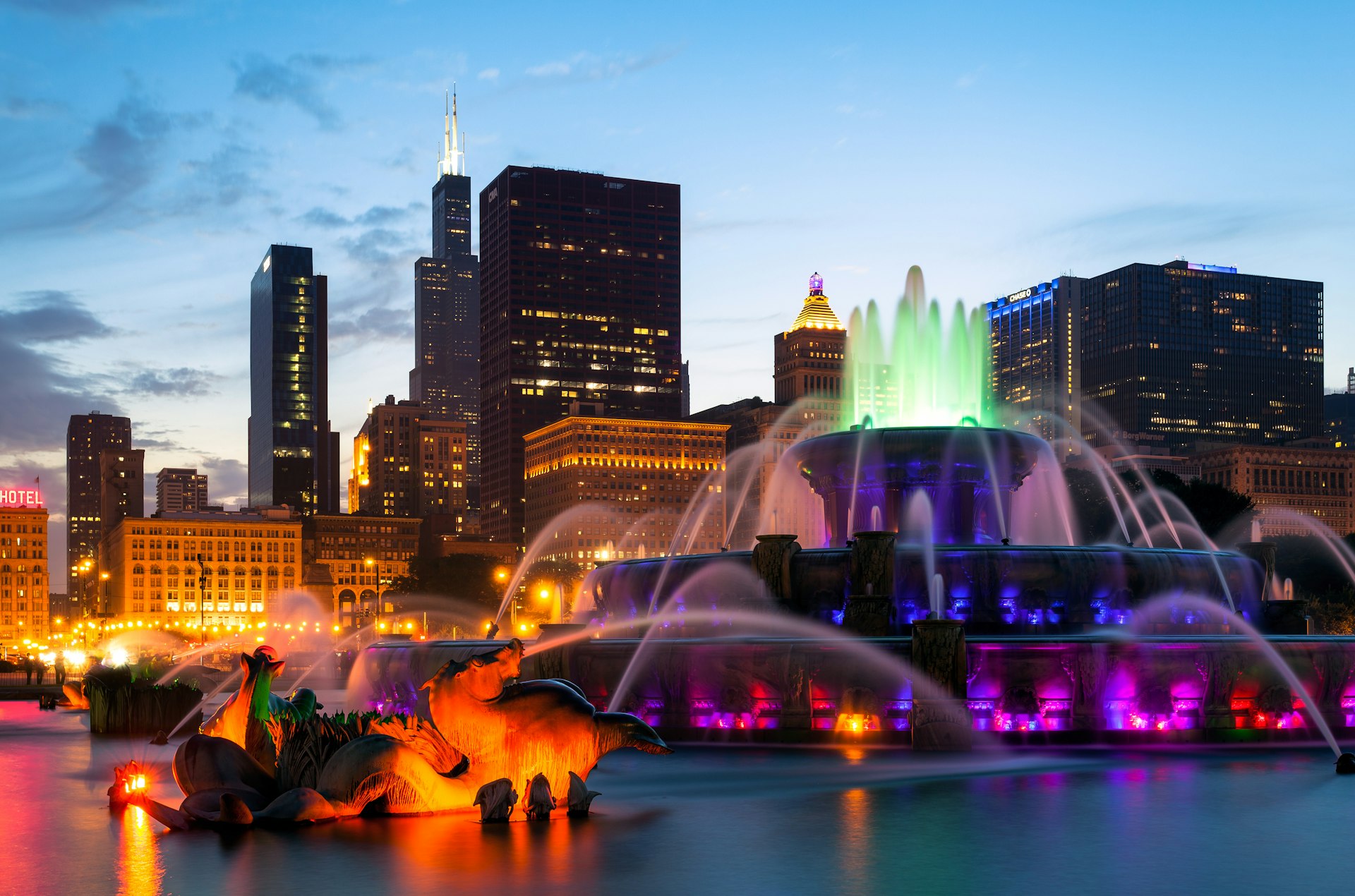 Buckingham Fountain lit up at sunset in Millennium Park, Chicago