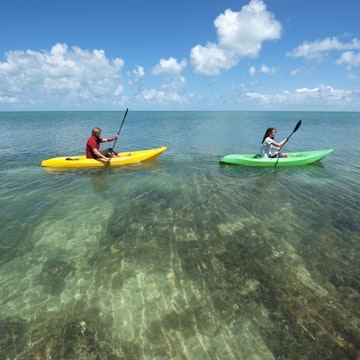 Man and a woman in kayaks at Key West.