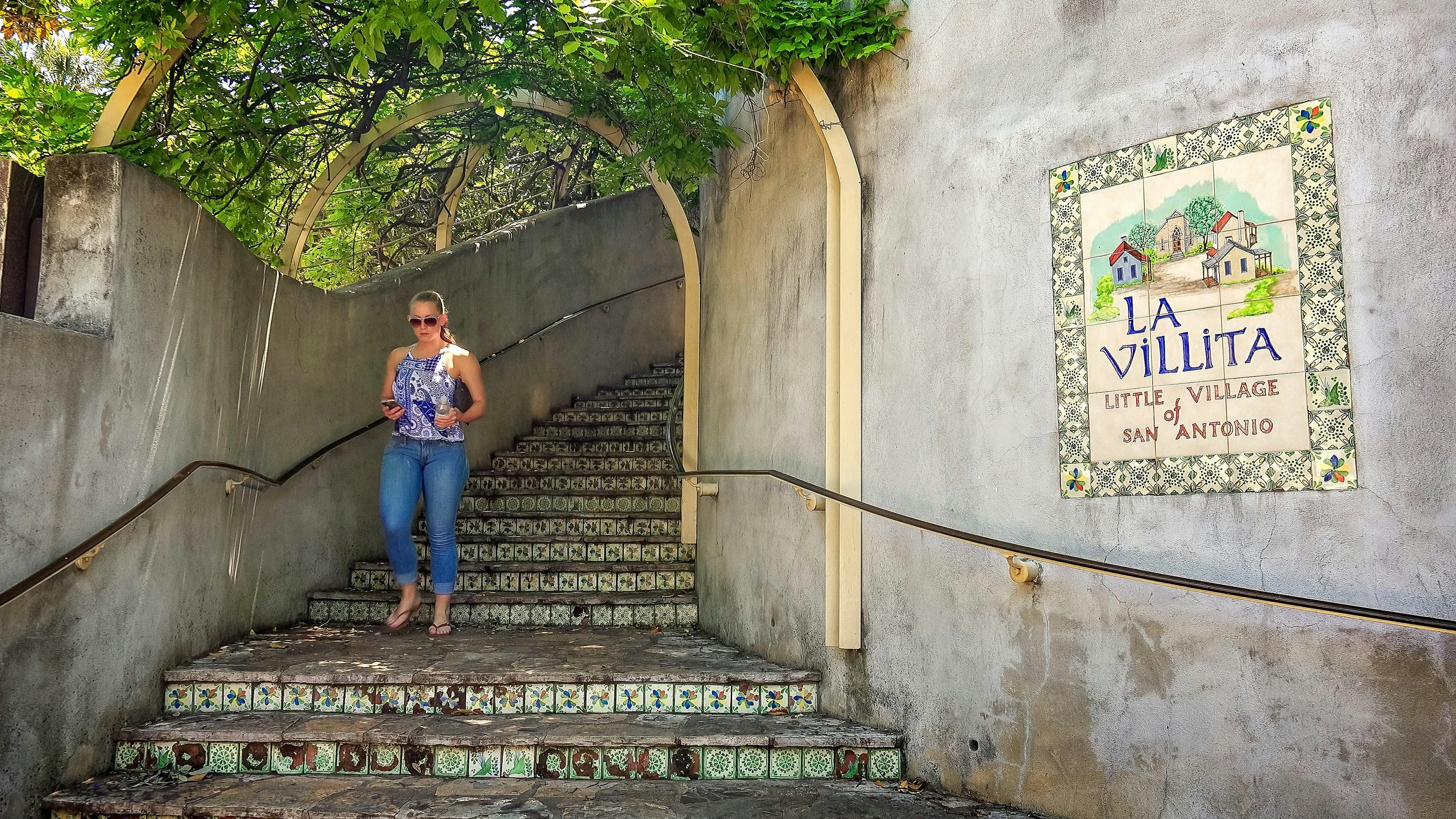 Woman walks down the steps at La Villita the little village of San Antonio, Texas
