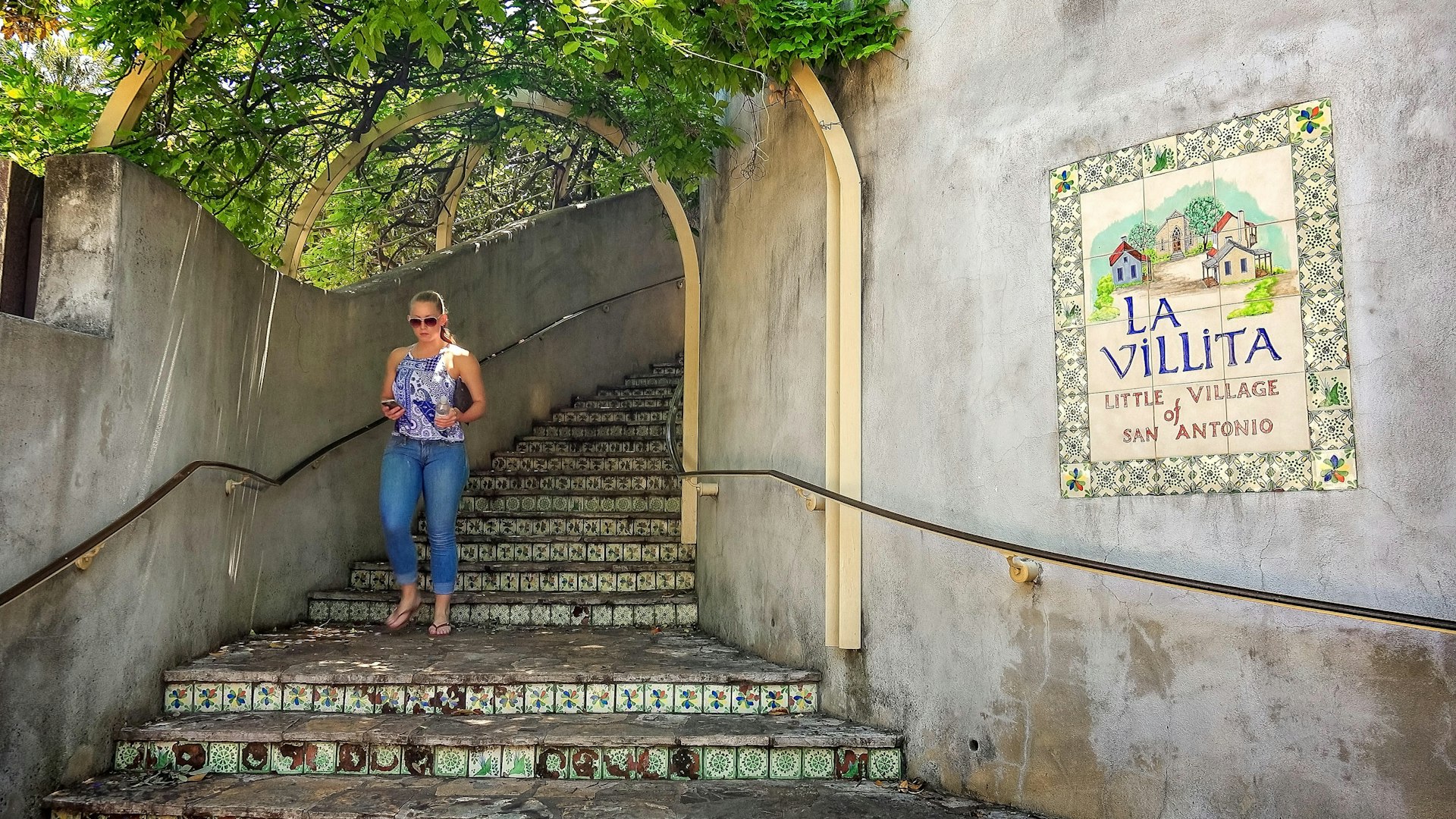 Woman walks down the steps at La Villita the little village of San Antonio, Texas