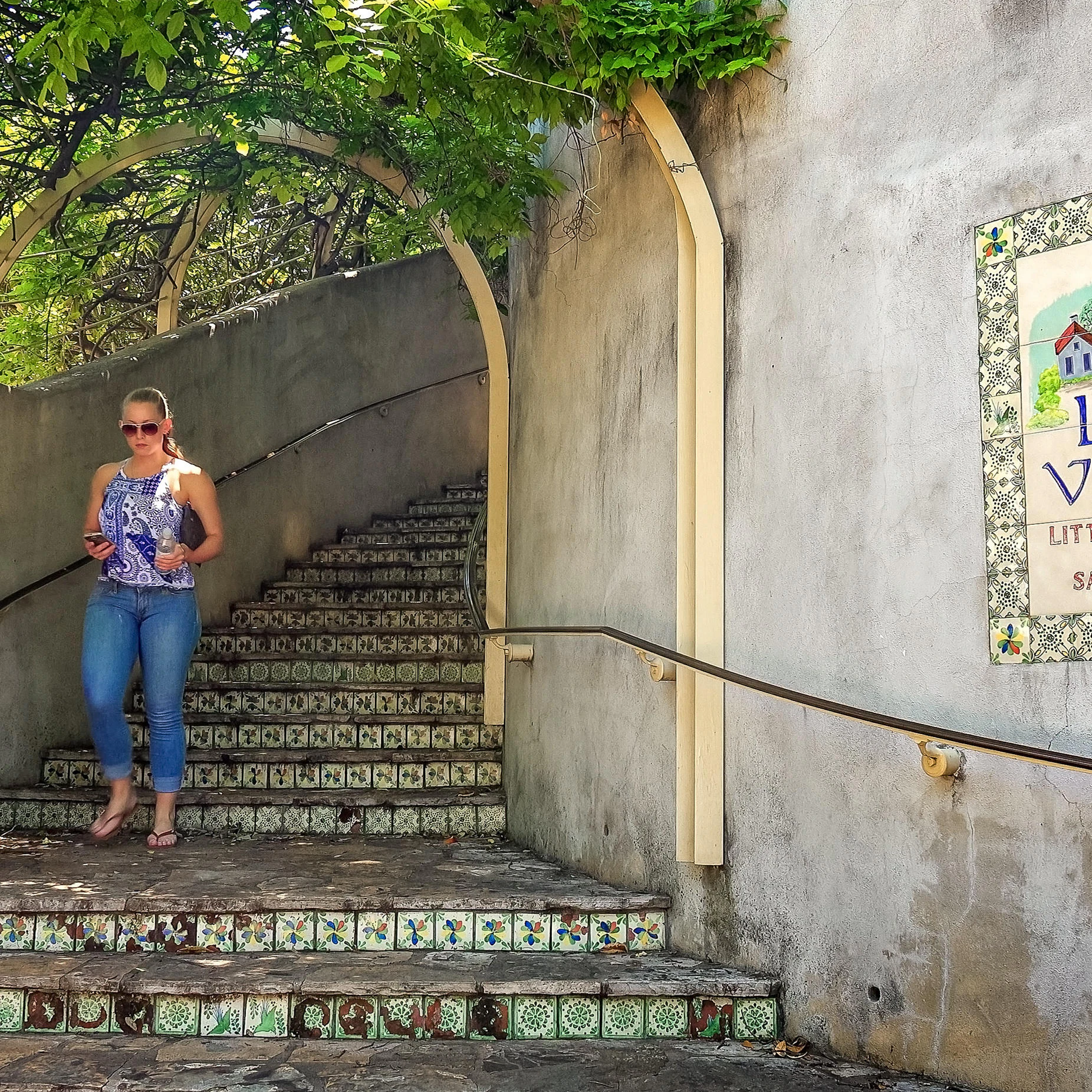 Woman walks down the steps at La Villita the little village of San Antonio, Texas