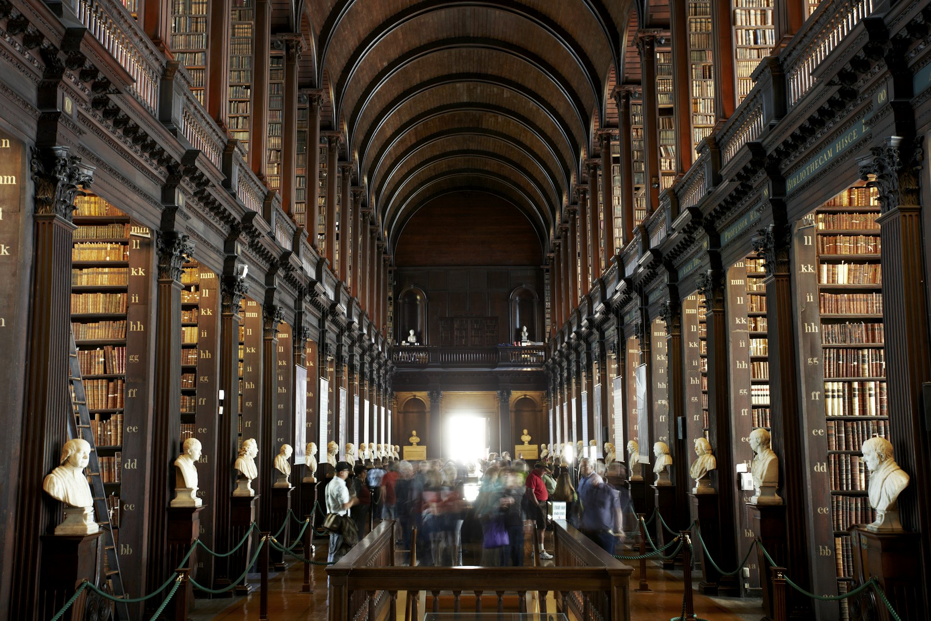 A dark, book-lined university room. 